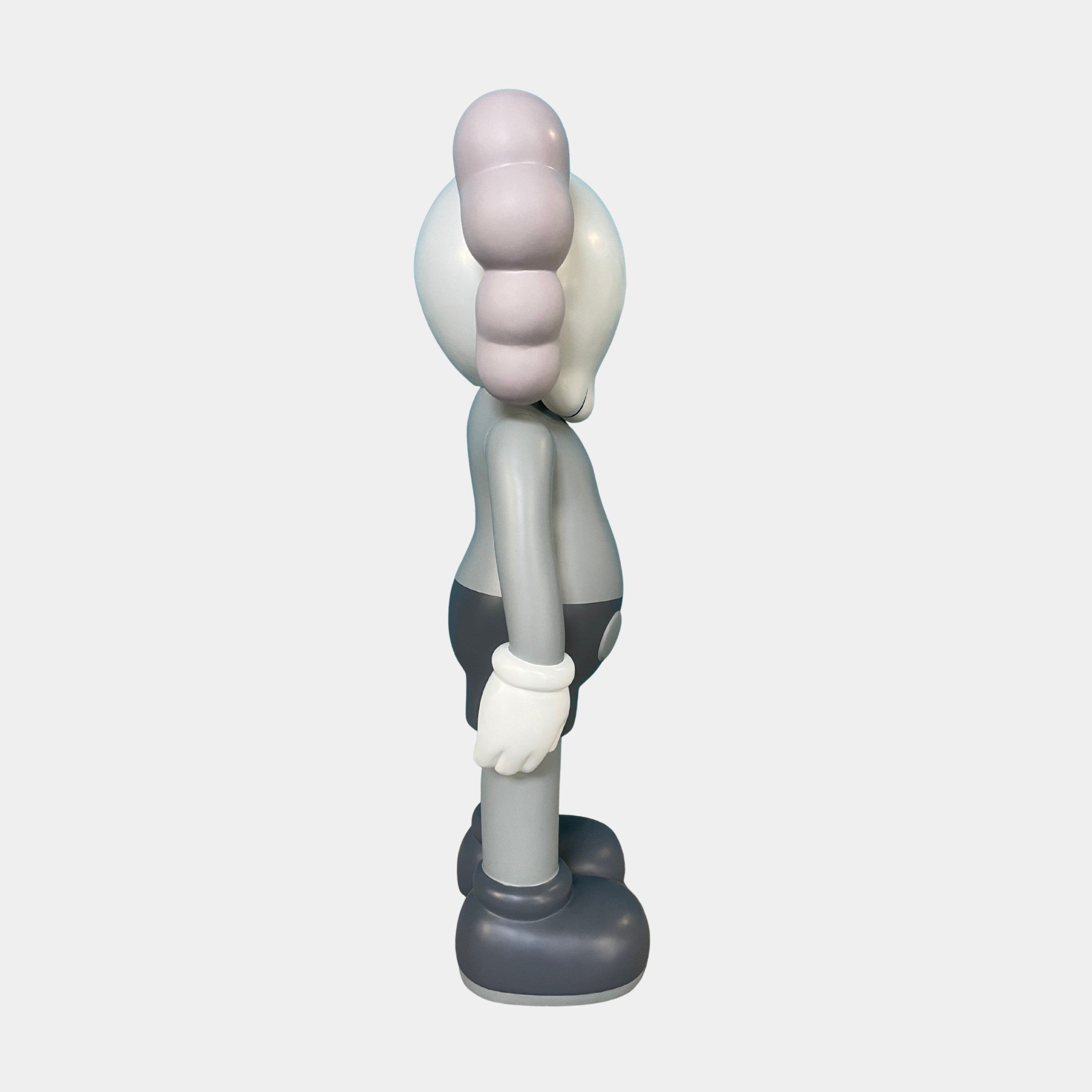 The Slate Grey Iconify Anatomy Sculpture (130cm) by Giant Sculptures is a gray and white cartoon-inspired vinyl figure with large gloves, rounded shoes, and an exaggerated head—an eye-catching piece of contemporary art decor.
