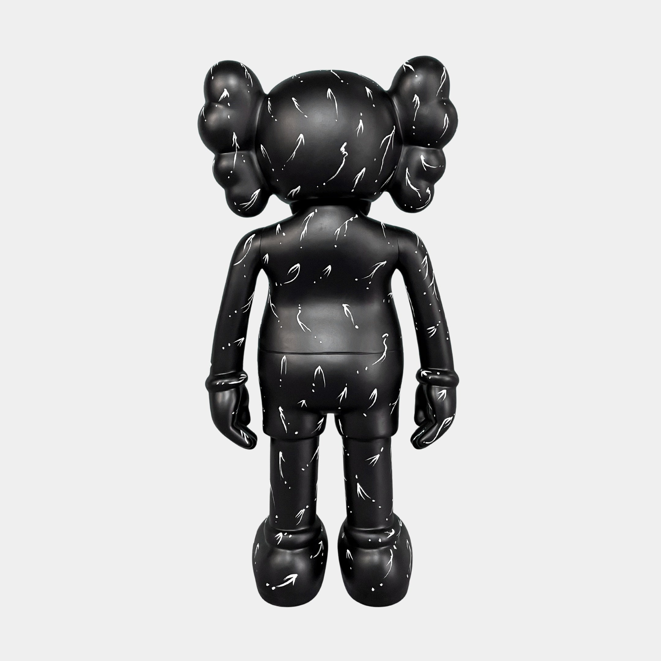 The Black Stone Iconify Standing Sculpture - 168cm by Giant Sculptures features a black, cartoon-style figure with round ears, glove-like hands, and white squiggly lines, standing against a plain white background.