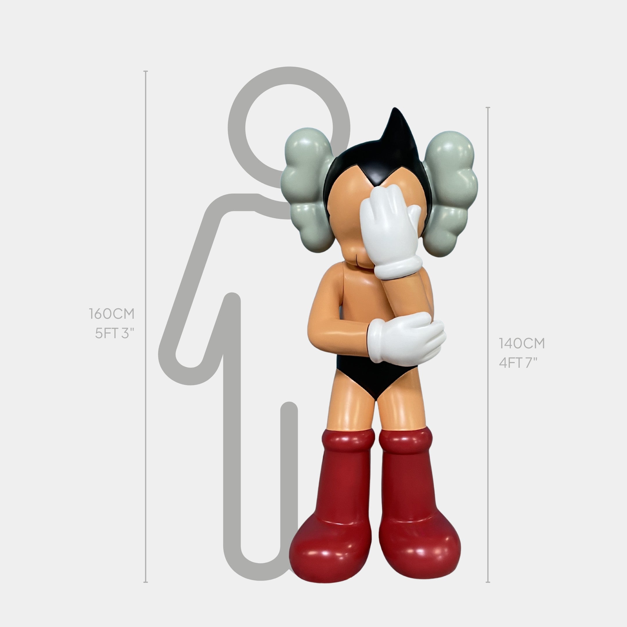 The Giant Sculptures "Fiery Red Iconify Cosmic Boy" is a 140cm-tall resin sculpture featuring black hair, white gloves, red boots, and tan skin, shown in front of a height chart with one hand covering its face.