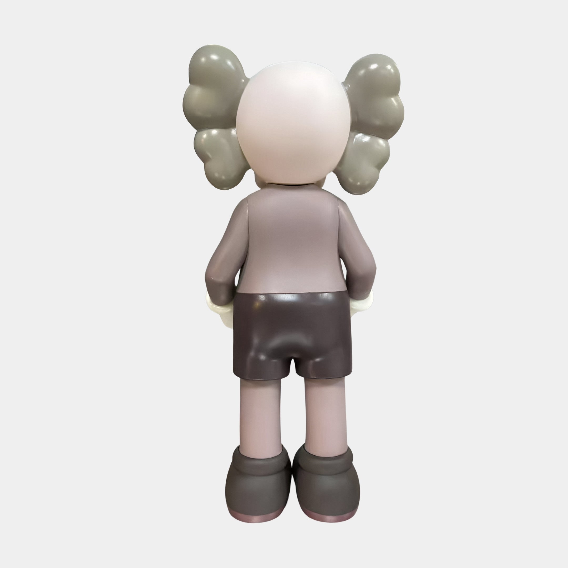 Rear view of the Giant Sculptures Driftwood Grey Iconify Dollars Figure 30cm, showing grey cloud-shaped ears, mauve top, brown shorts, on plain background.