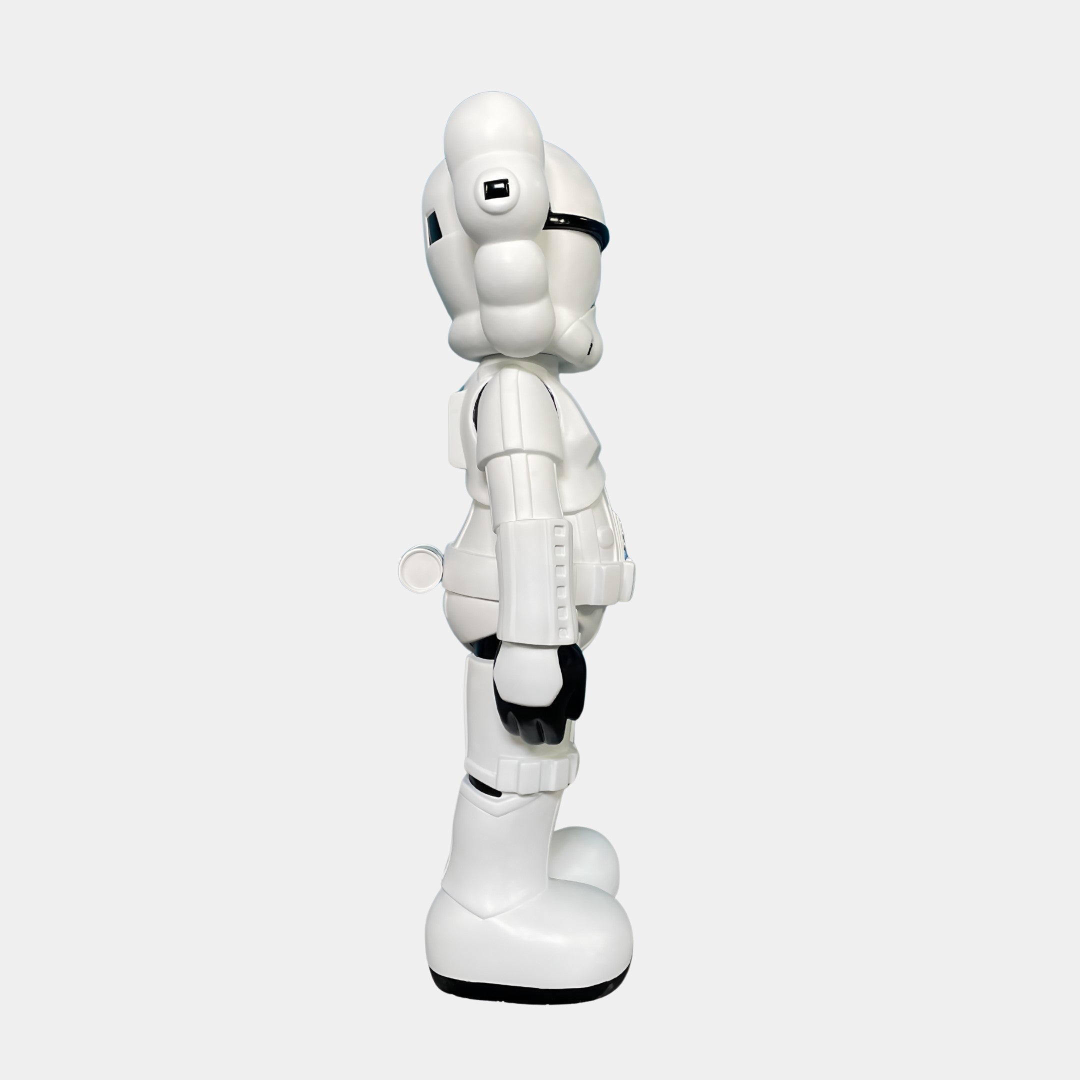The Giant Sculptures Black & White Iconify Enforcer Figure (26cm) features a cartoon-like, dual-tone design with a rounded helmet, black gloves, and large boots—perfect for contemporary art collections.
