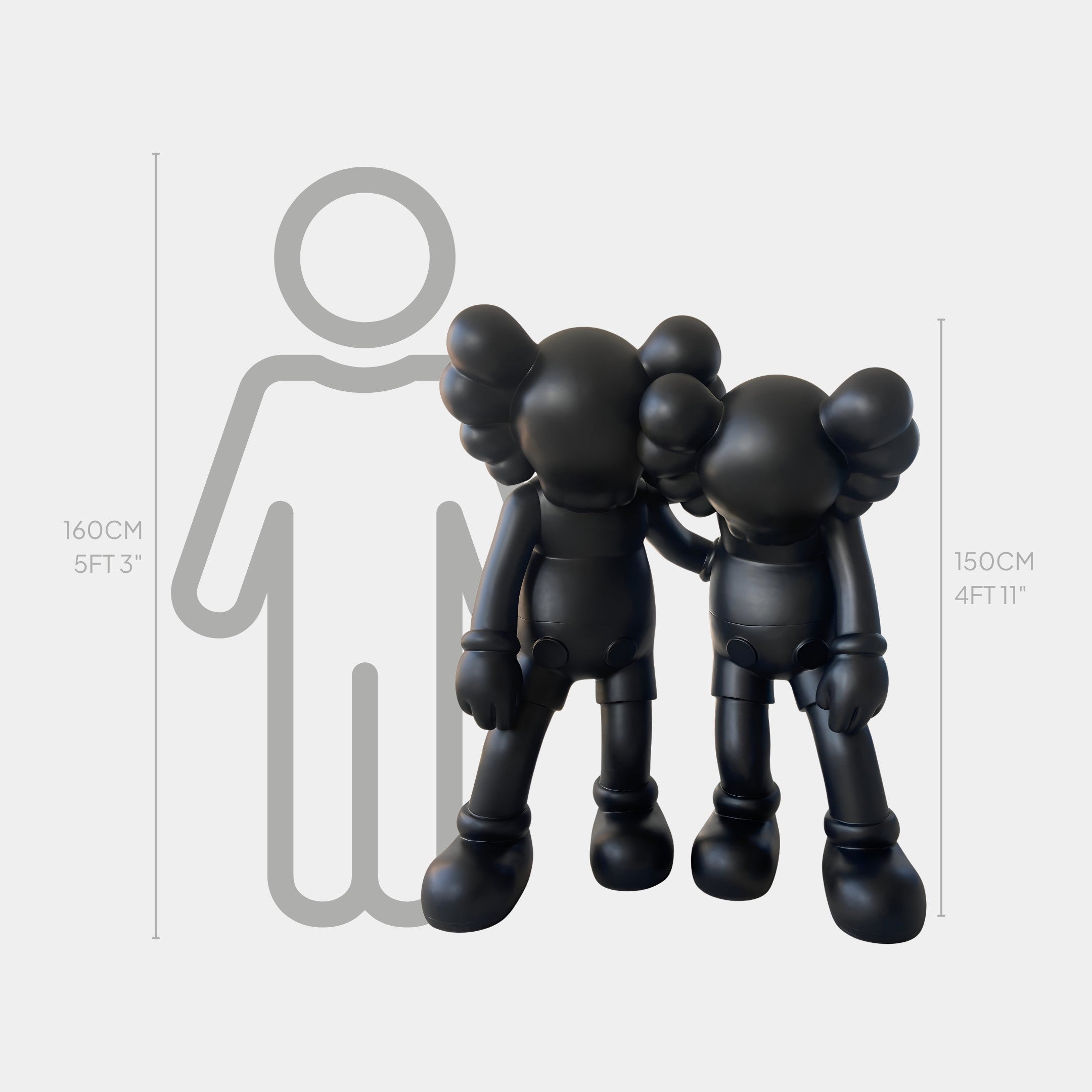 The Midnight Black Iconify Friendship Sculpture by Giant Sculptures stands 150cm tall. Two black, cartoon-inspired figures with large hands, feet, and rounded ears pose in front of a height chart for a striking modern resin art display.