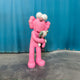 The Giant Sculptures Petal Pink Iconify Loving Furry Sculpture (135cm) features a pink, furry figure with large white eyes, hugging a small gray figure on a gray floor—an adorable artistic home decor piece.