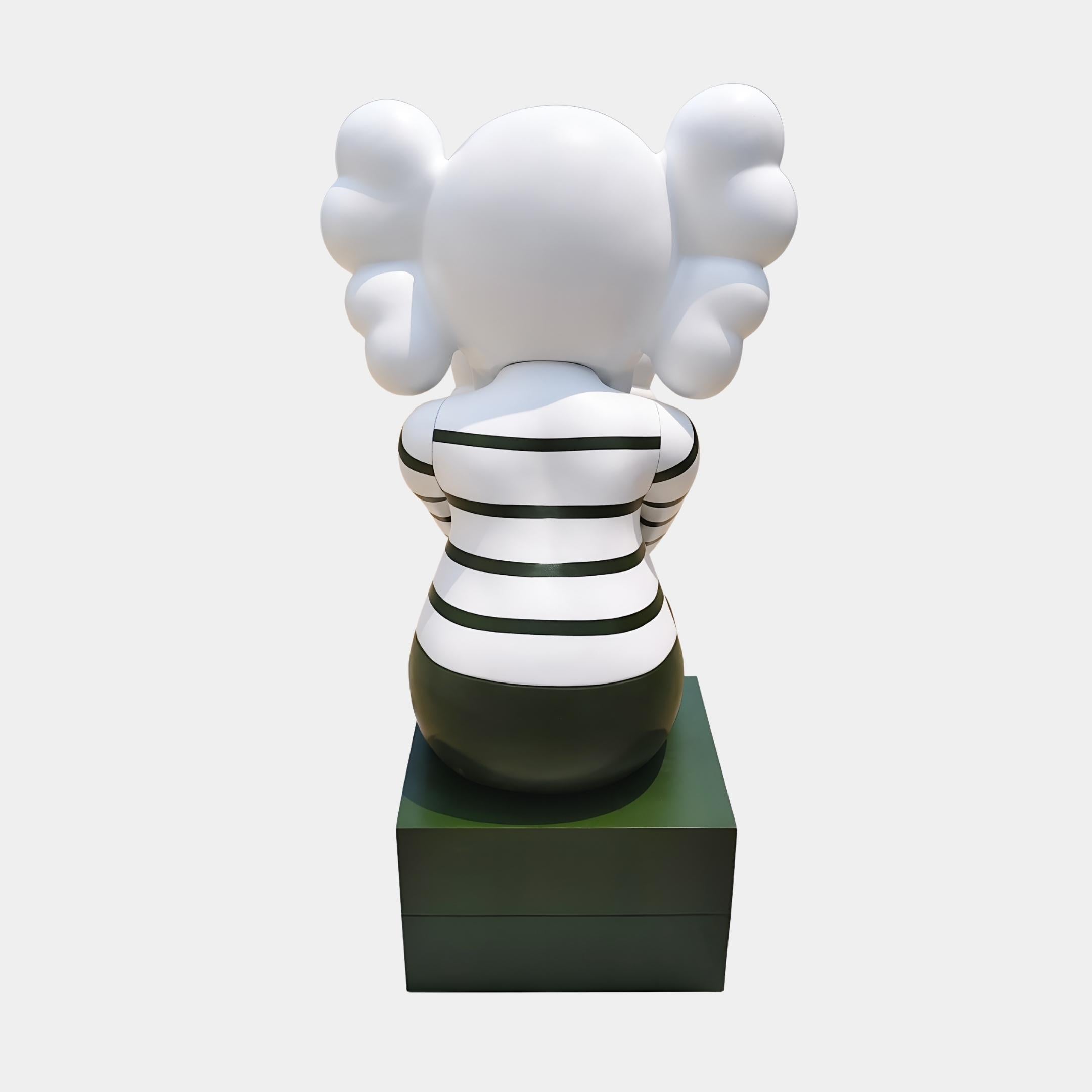 Rear view of the Forest Green Iconify Mime Sitting Sculpture - 135cm, showing the black and white striped back, rounded Iconify head and forest green block base.