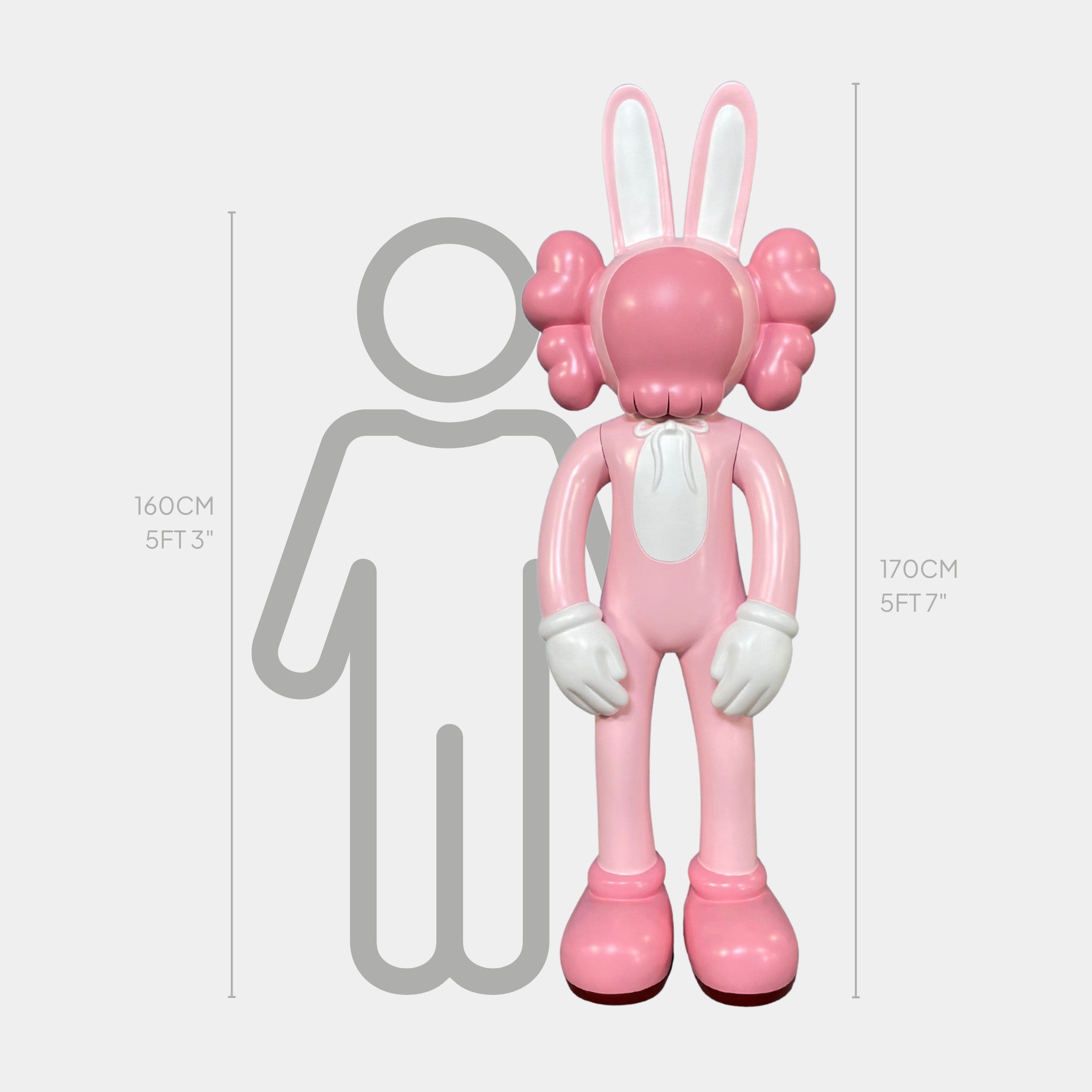 The Coral Pink Iconify Rabbit Sculpture (170cm) by Giant Sculptures, styled like a cartoon with big gloves and shoes, stands next to a 160 cm outline for scale, showing it is slightly taller than the figure.