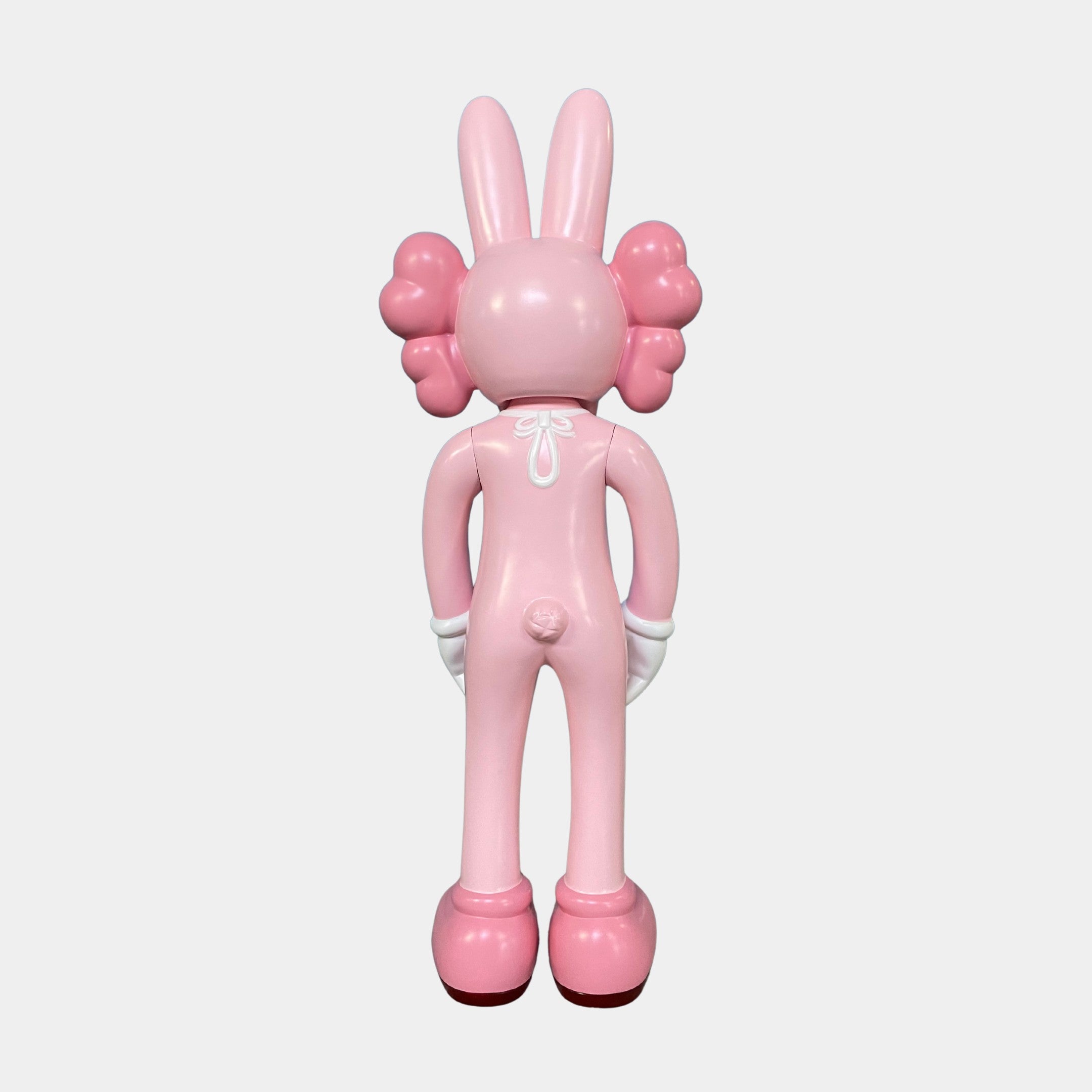 The Coral Pink Iconify Rabbit Sculpture (130cm) by Giant Sculptures features a cartoon-like bunny with puffy cheeks, small tail, and white gloves—ideal as a playful contemporary decor piece on a plain white background.