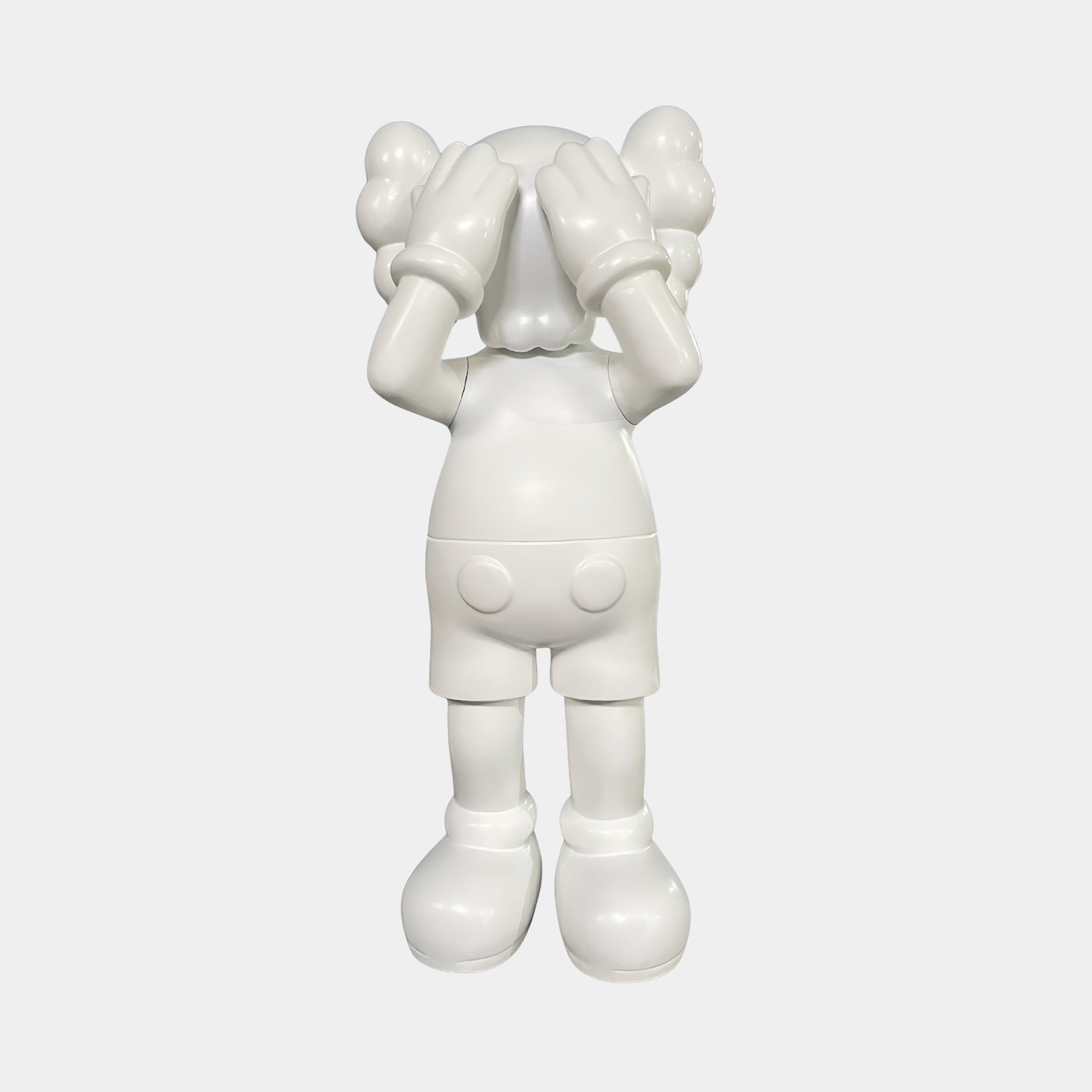 The Cloud White Iconify Silent Cry Sculpture - 91cm by Giant Sculptures is a modern, minimalist piece featuring a cartoon-like figure with gloved hands over its face—ideal for contemporary art decor.