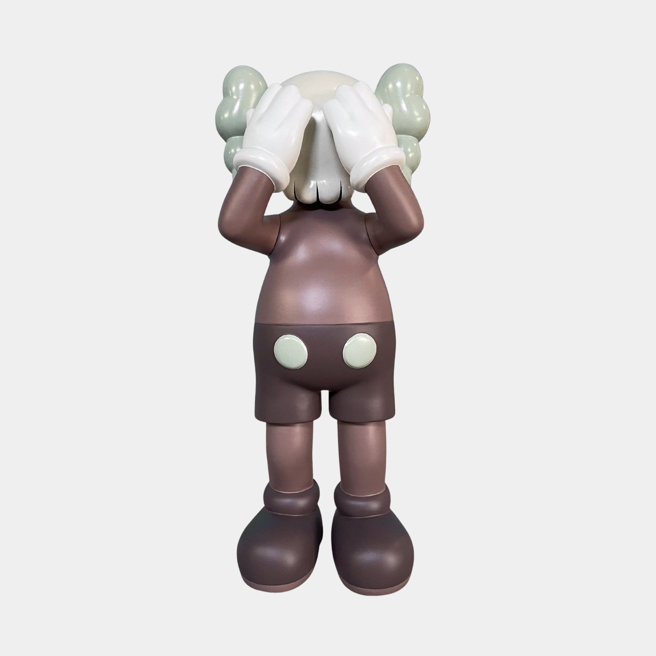 The Hazelnut Brown Iconify Silent Cry Sculpture (91cm) by Giant Sculptures features a stylized cartoon figure with gloved hands covering its face—an eye-catching piece of contemporary art decor for any space.