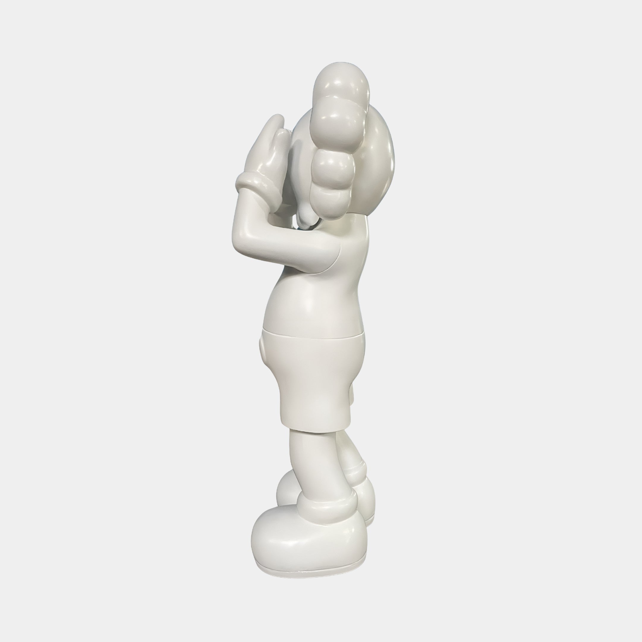 The Cloud White Iconify Silent Cry Sculpture - 91cm by Giant Sculptures features a glossy white finish, round shapes, gloved hands, and large shoes, standing upright with one hand covering its face—a striking piece for modern art decor.
