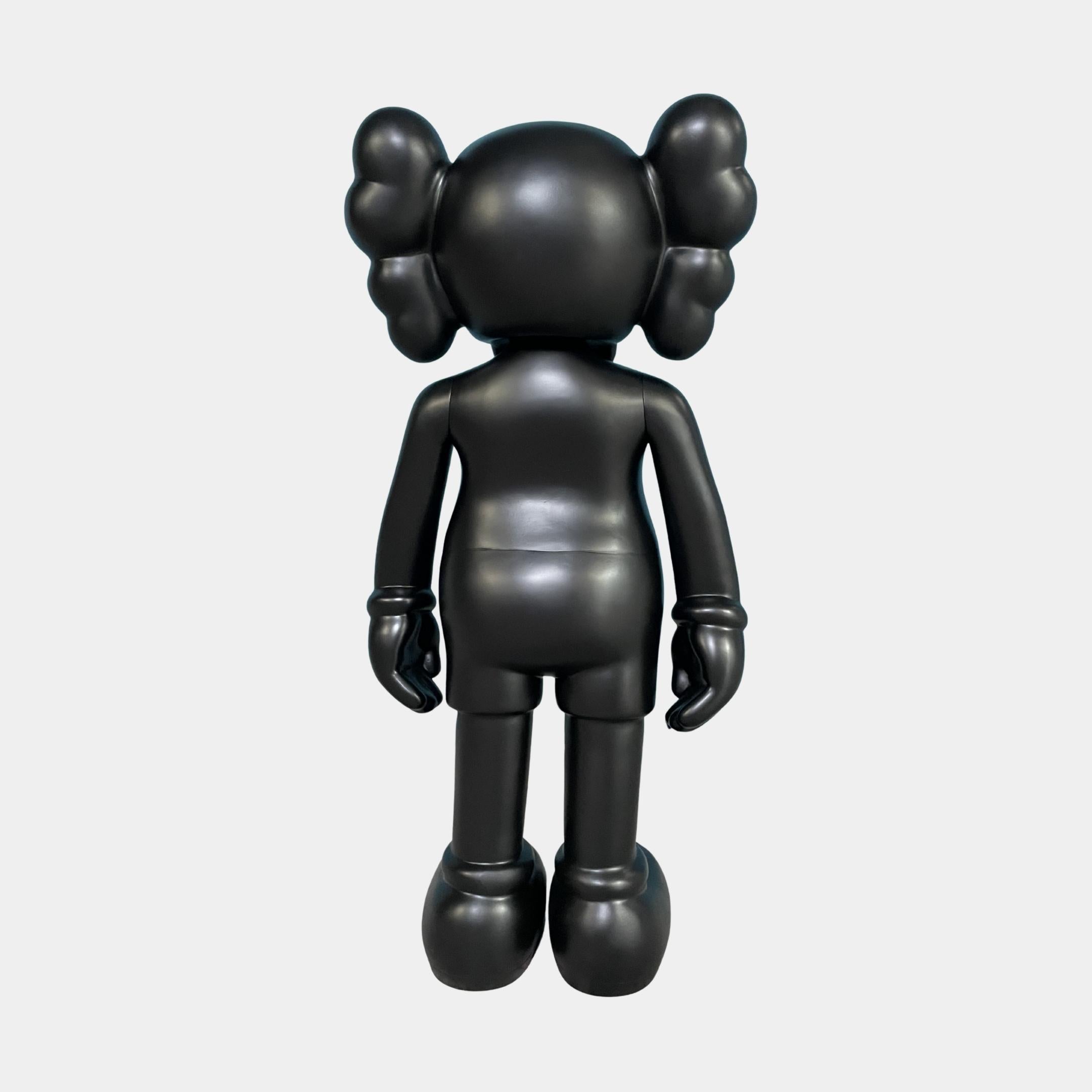 Rear view of the Giant Sculptures Midnight Black Iconify Standing Figure 37cm, showing the rounded torso, three puffy head protrusions, and planted feet on a plain background.