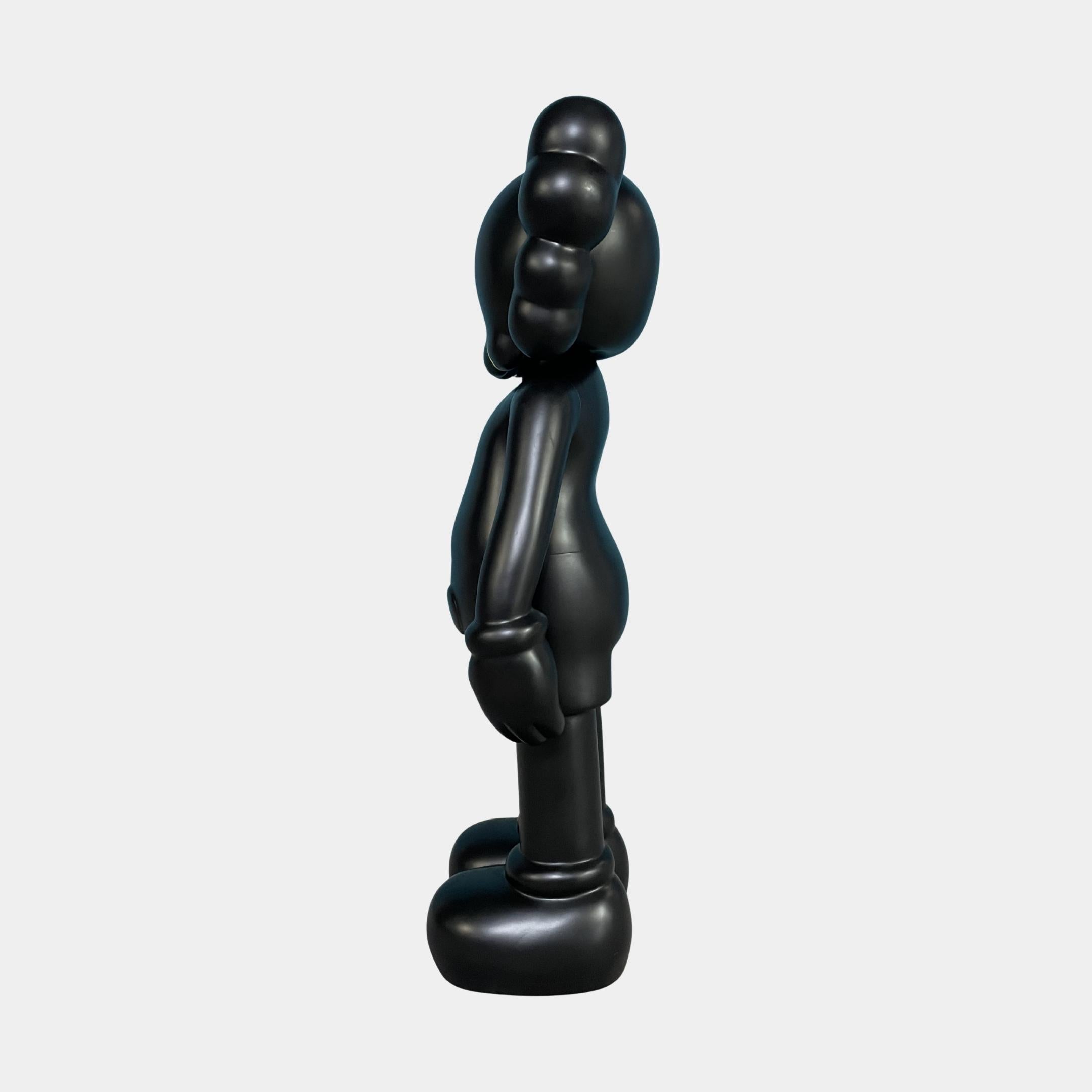 Side view of the Giant Sculptures Midnight Black Iconify Standing Figure 37cm, showing the rounded torso, gloved hand at the side, and oversized foot against a plain background.
