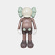 The Hazelnut Brown Iconify Standing Figure by Giant Sculptures is a 20cm stylized polyvinyl sculpture with gray pants featuring light green circles, big white gloves, puffy pale green ears, and a round head. It stands facing away on a plain white background.