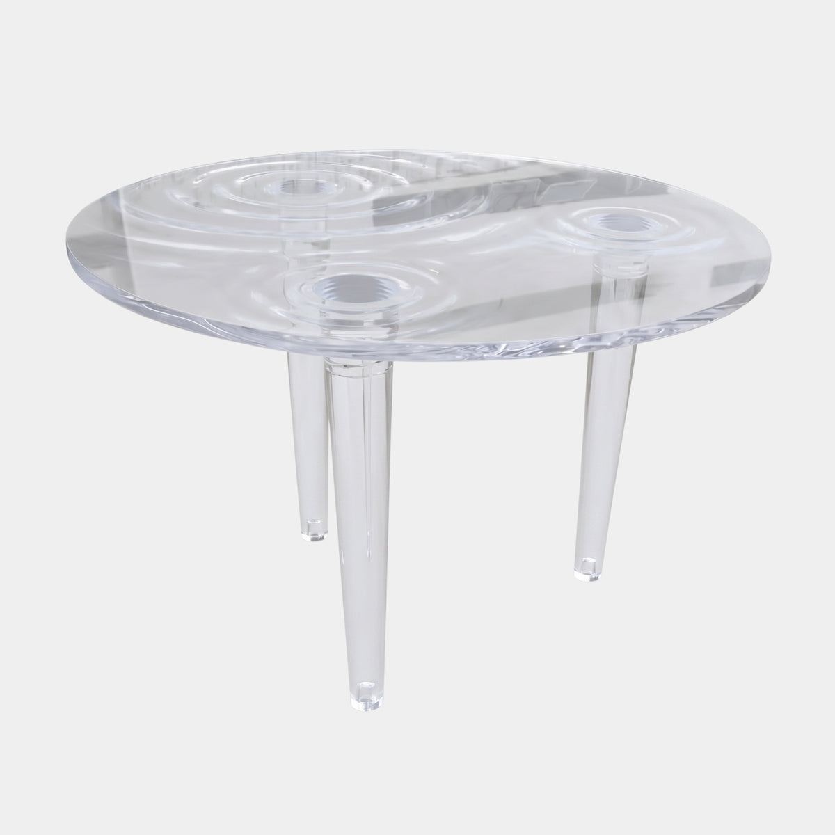 Colourless Droplet Relief Cast Resin Poseur Table (140cm) by Giant Sculptures, clear resin top with rippling concentric circles on three tapered legs, plain white background.