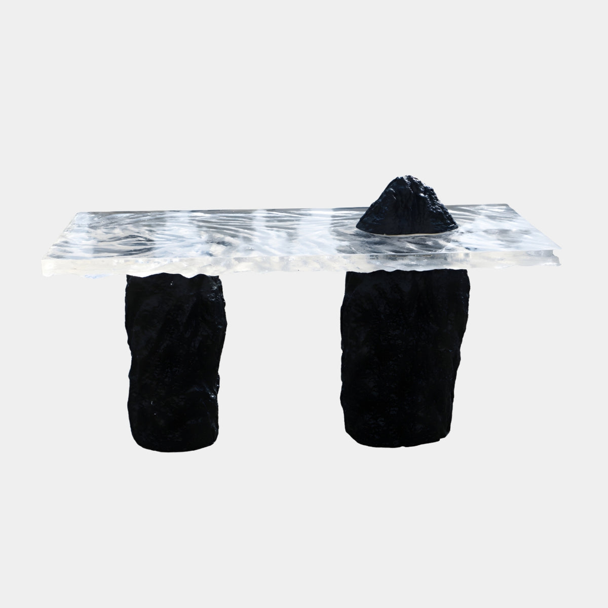 Clear Rippled Slab Black Rock Peak Resin High Table, 160cm, with a black rock peak on a rippled clear resin top set on two rough black pedestals, white background.