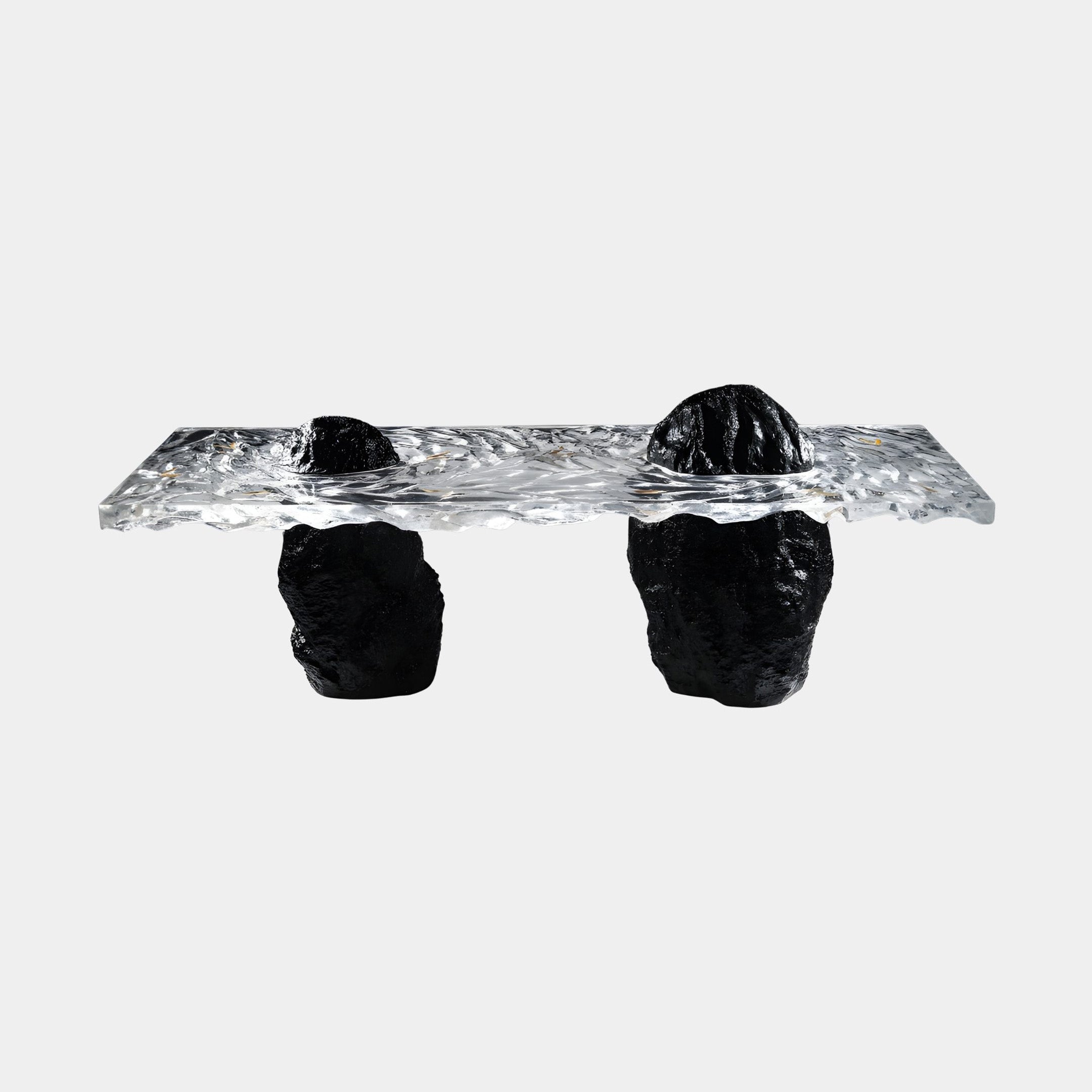 Giant Sculptures Black Volcanic Rock Textured Clear Resin Coffee Table 240cm with a rippled transparent top resting on raw dark stone legs, shown on a plain background.