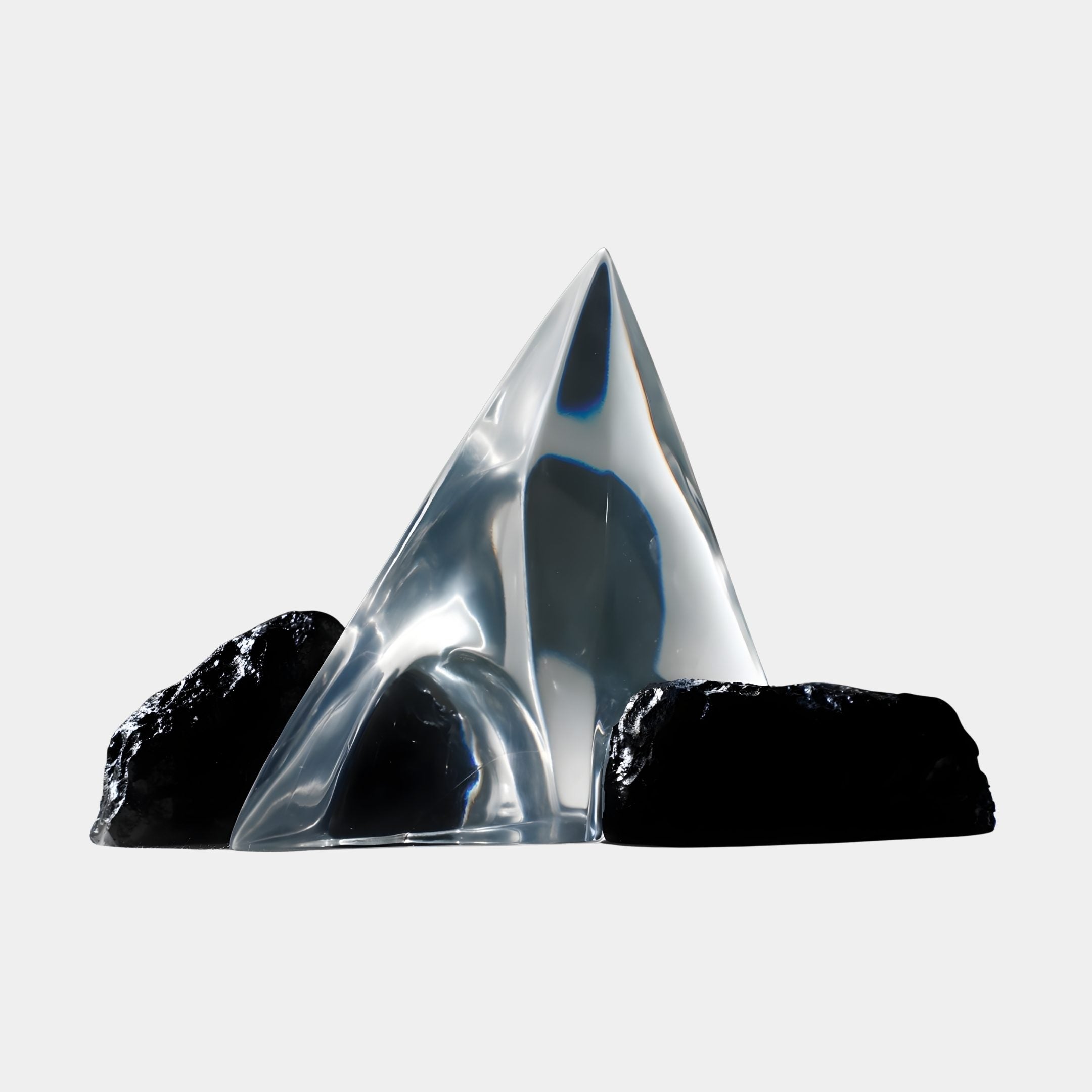Clear Pyramidal Resin & Obsidian Rock Sculpture by Giant Sculptures, a faceted transparent pyramid flanked by glossy black obsidian, on a plain background.