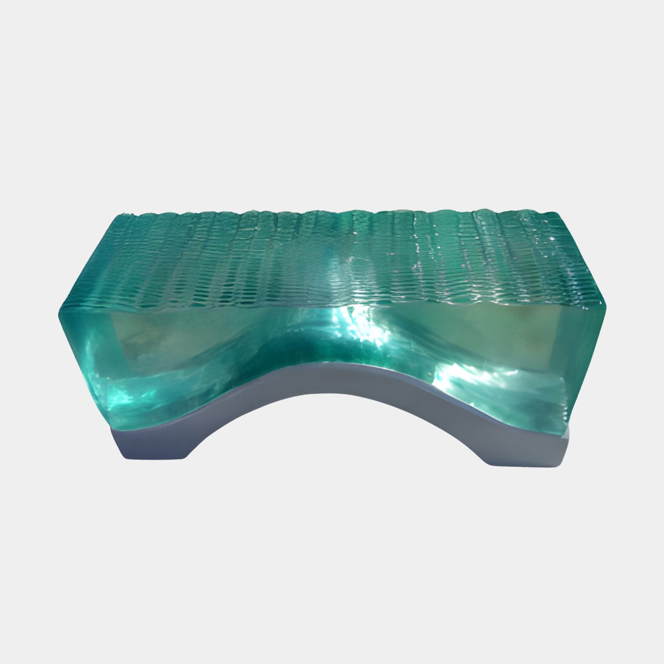 Emerald rippled glass arched console by Giant Sculptures, with a luminous green crest flowing over a sculpted grey base, shown against a plain white background.