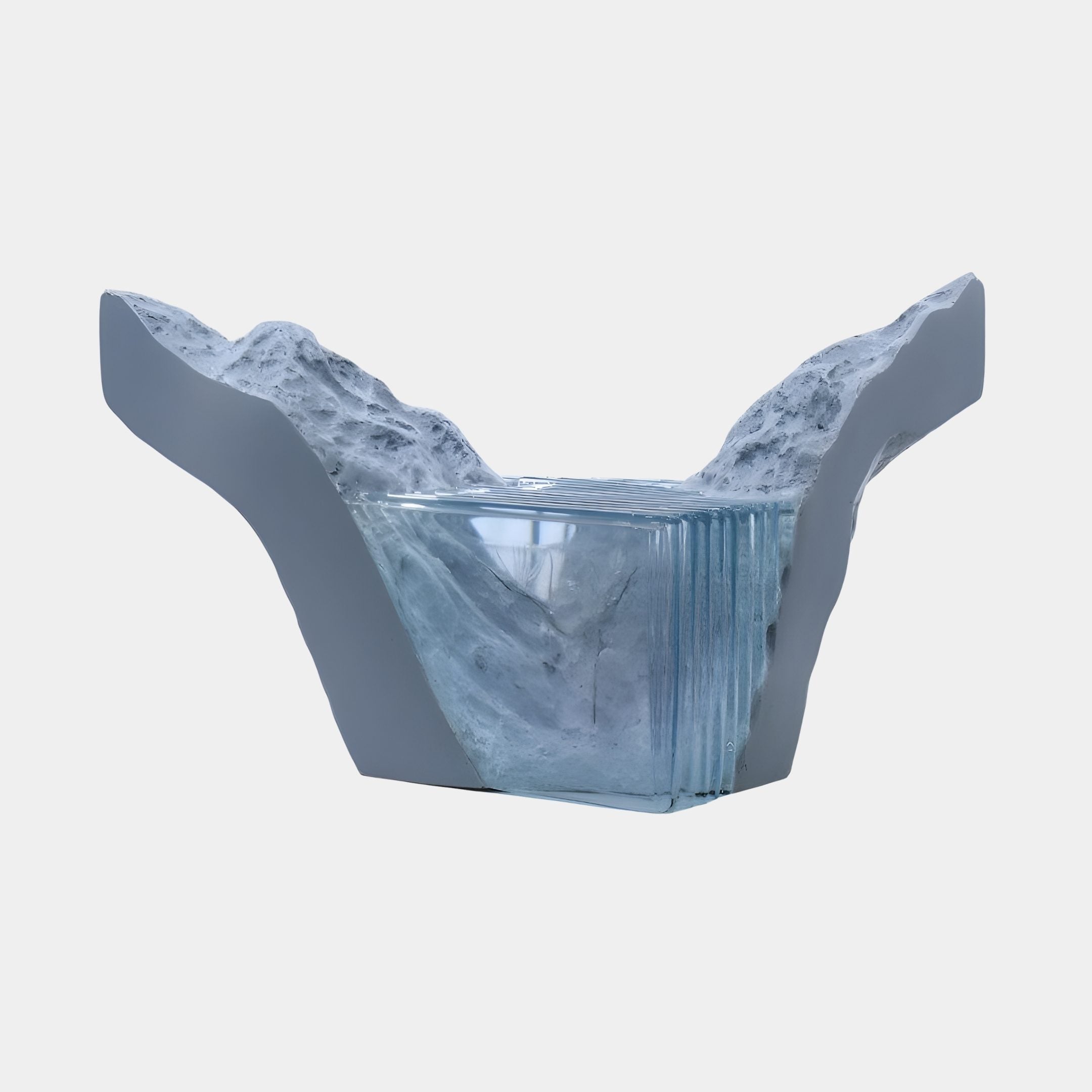 Slate grey resin and fibreglass mountain valley sculpture by Giant Sculptures, cradling a pool of clear blue glass between rugged peaks, on a plain background.
