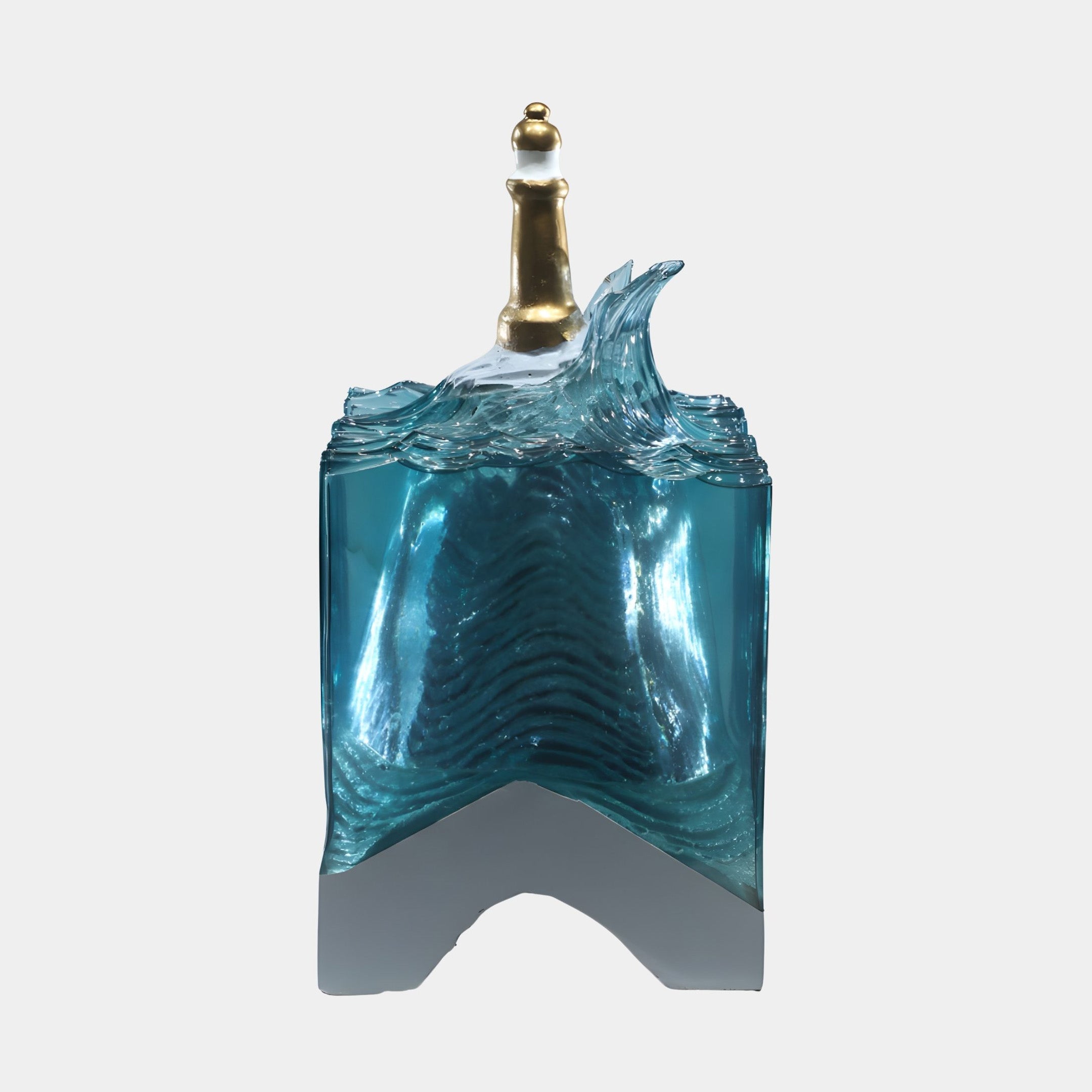 Giant Sculptures' 55cm Blue Cresting Wave Gold Lighthouse resin sculpture with a translucent teal block, white foam crest, and gold lighthouse on a plain background.