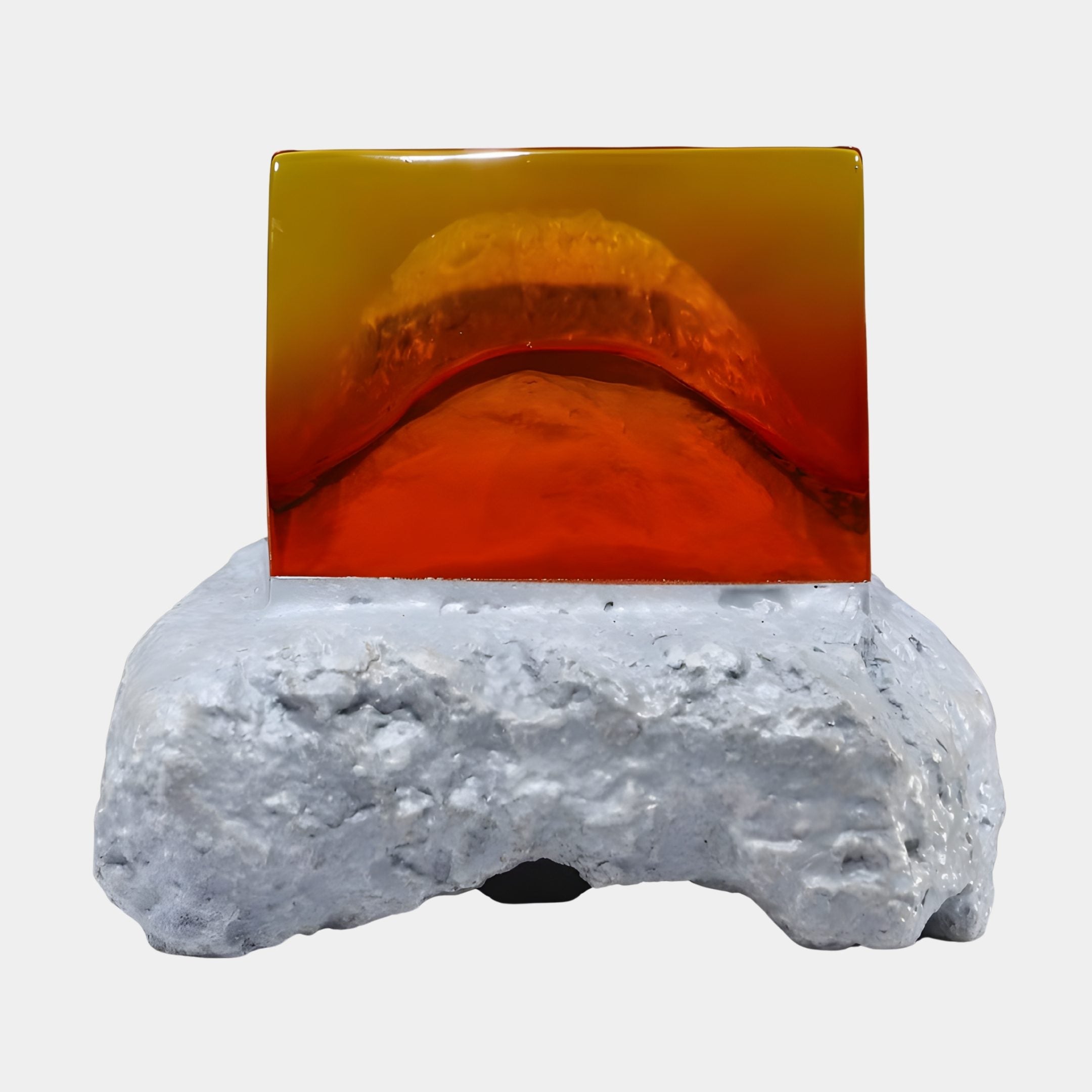 Amber Resin Sunset Landscape on White Stone Sculpture by Giant Sculptures, with a glowing orange resin block above a rugged white stone base.