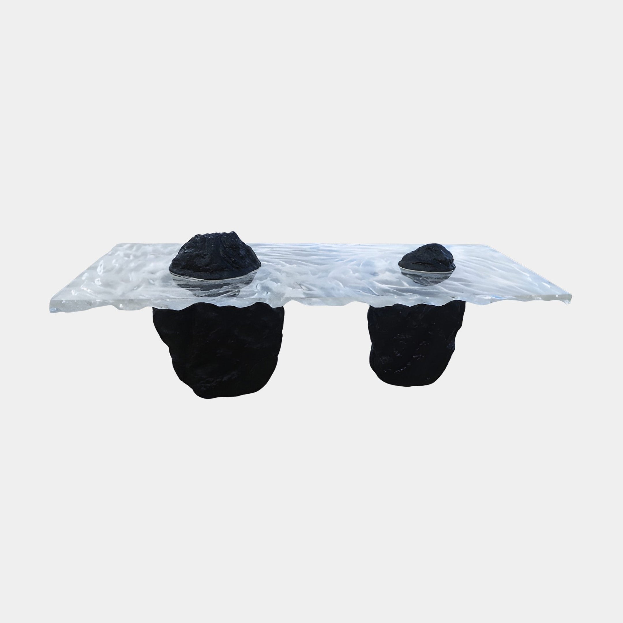 Clear Resin Slab on Black Rock Pair Console 240cm by Giant Sculptures, featuring a rippled transparent top resting on two rugged black stone legs against a plain background.