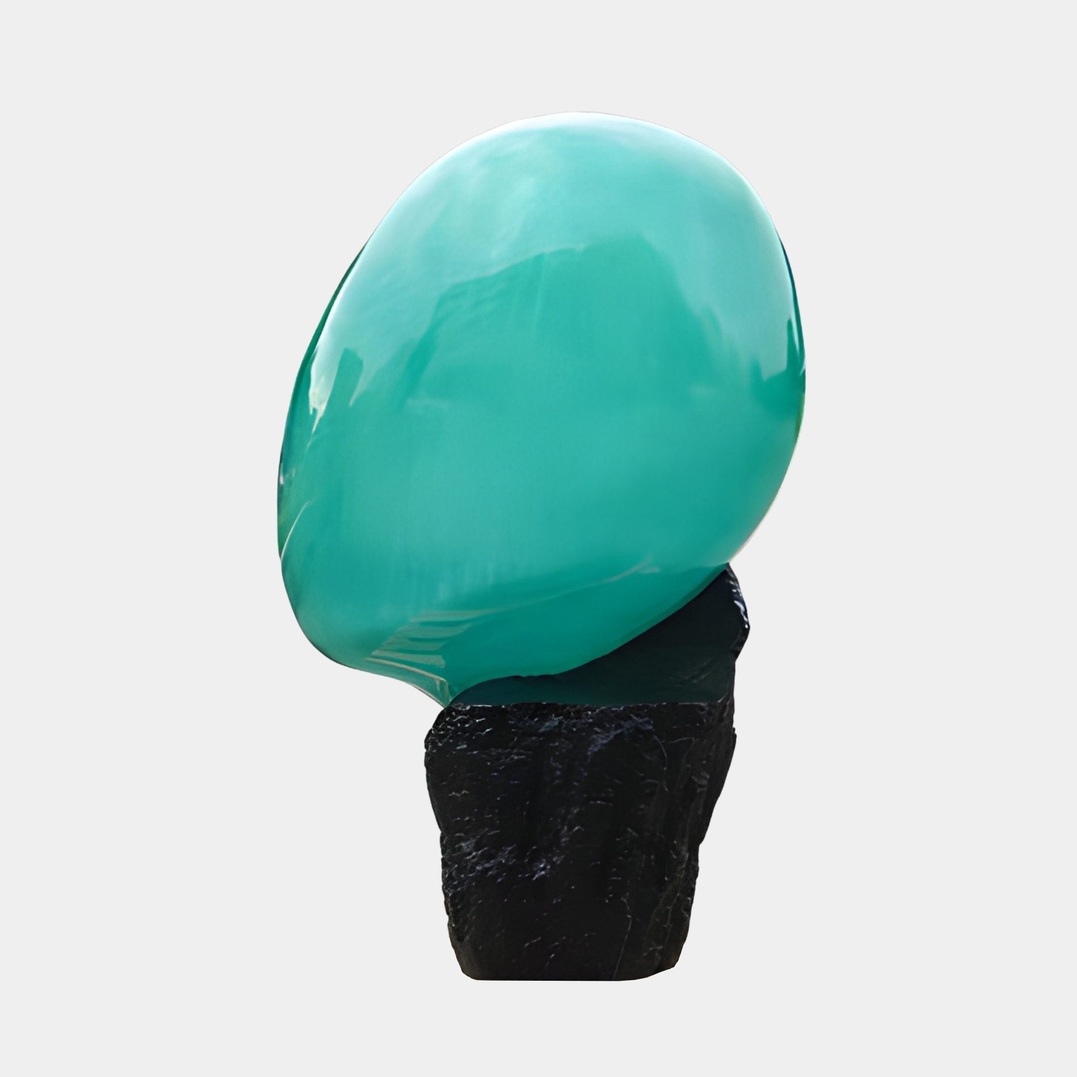 Giant Sculptures Teal Smooth Pebble on Black Rock 124cm resin sculpture, glossy sea-green orb resting on a rugged black stone base, plain background.
