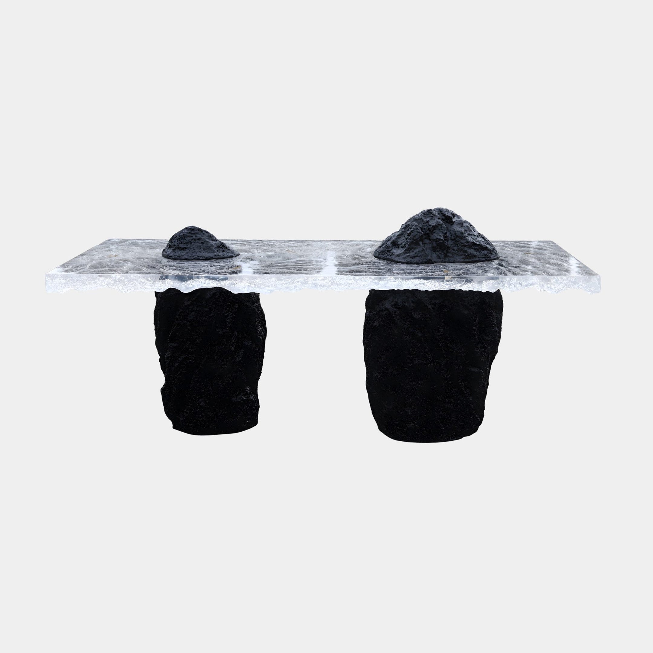 Giant Sculptures Clear Resin Slab on Twin Black Rock Console Bench 200cm shown front-on with two black textured rock mounds on the transparent slab, plain background.