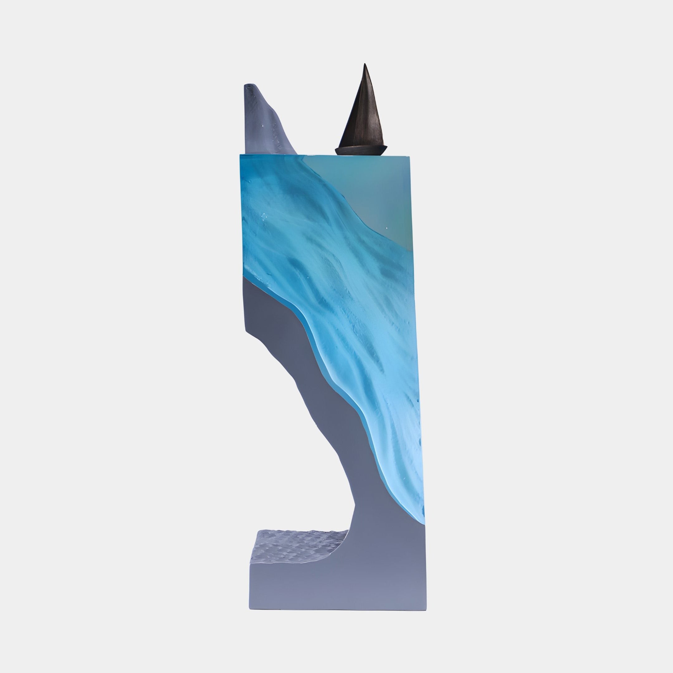 Giant Sculptures Teal Blue Translucent Sailboat & Iceberg Resin Pillar 121cm with flowing blue resin, grey body and dark sail peak on a white background.