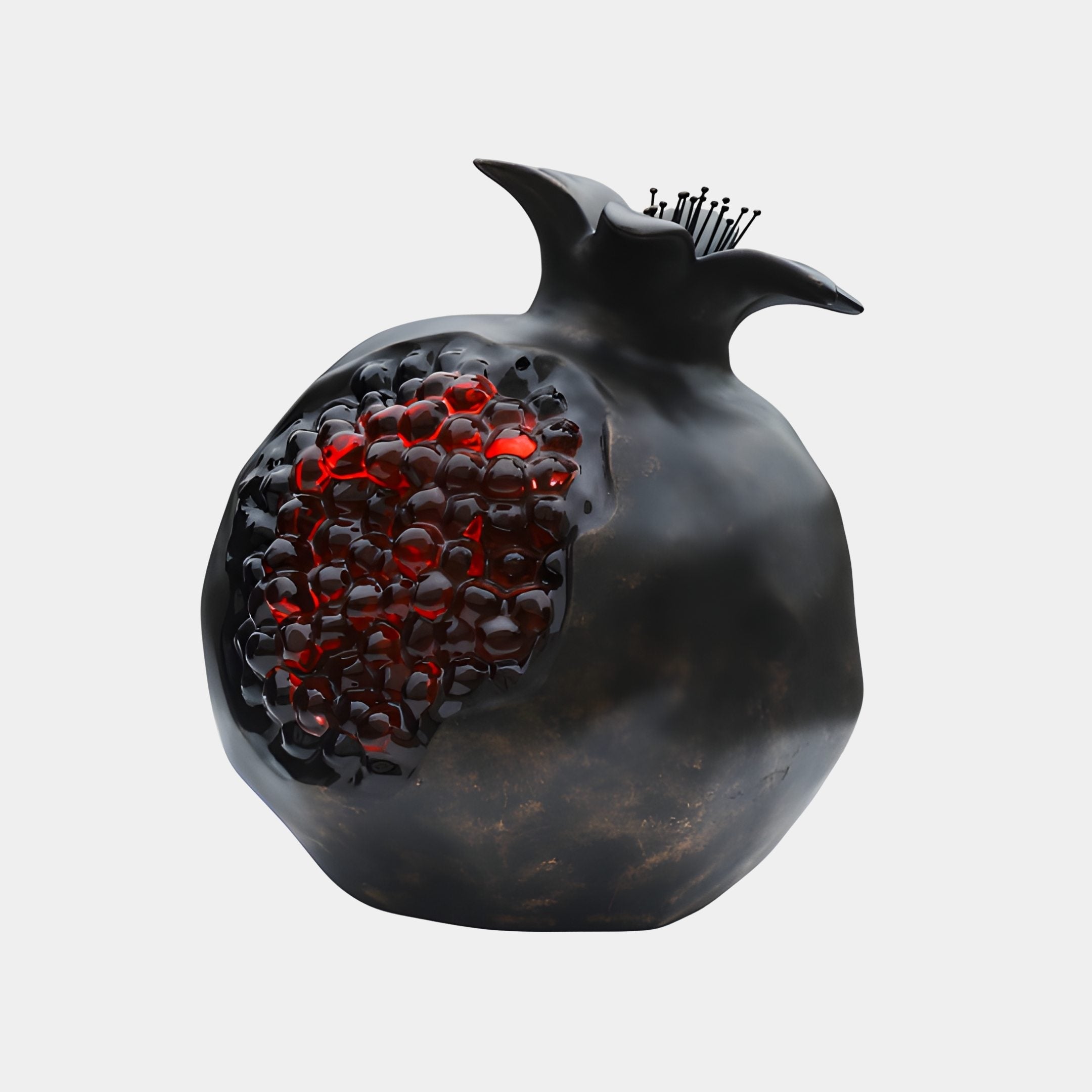 Deep Bronze & Red Seeded Pomegranate Sculpture by Giant Sculptures, 60cm, with a glossy dark shell split open to reveal glistening red resin seeds, on a plain background.