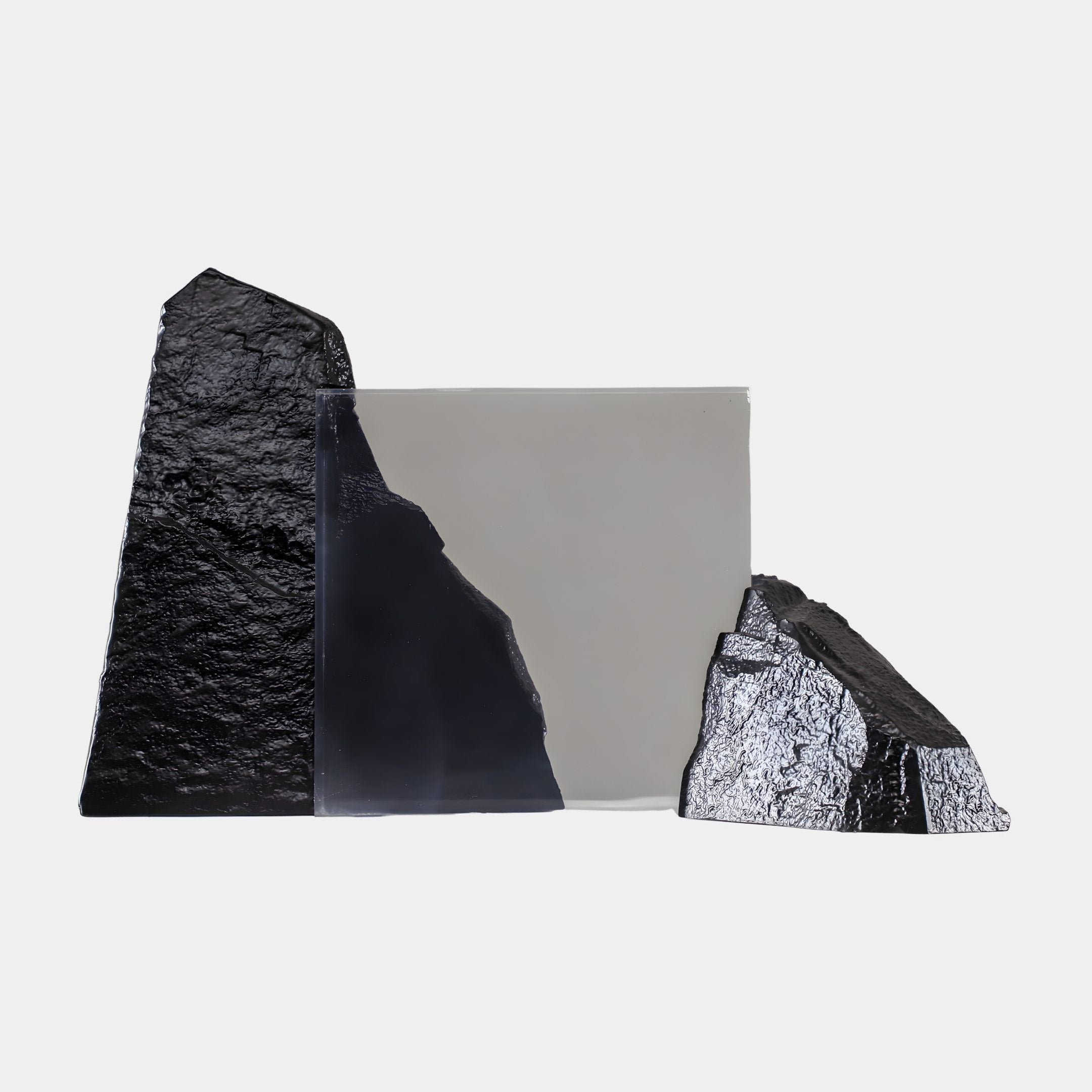Giant Sculptures Smoky Grey Resin Core & Dual Black Rock Fiberglass Sculpture 70cm, with a translucent grey core between two textured black rocks on a light background.