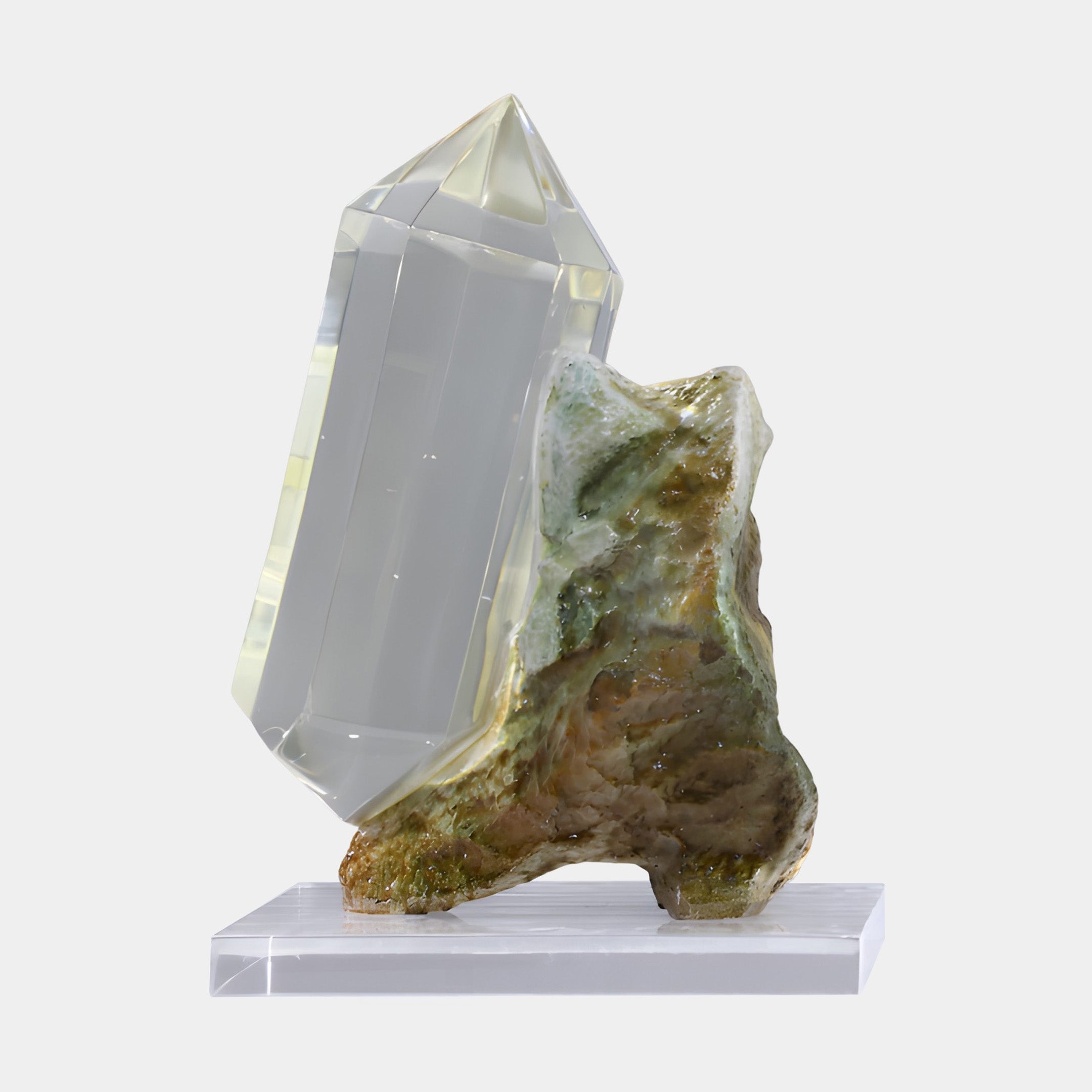 Clear Faceted Resin Quartz & Mossy Stone Fiberglass Sculpture by Giant Sculptures, with a glassy crystal spire rising from a green-bronze rock on an acrylic base.
