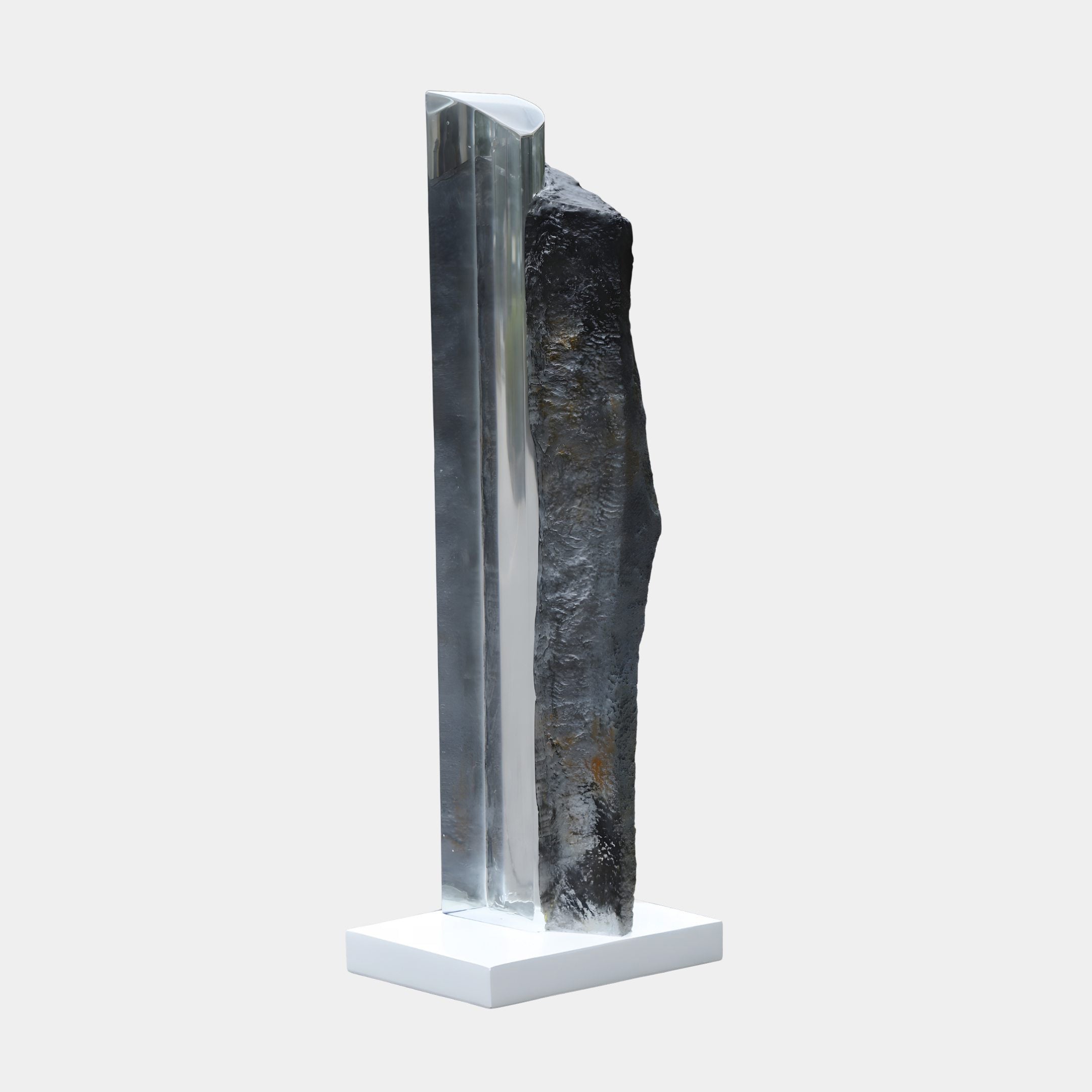 Giant Sculptures Clear Resin Crystal Peak on Rock Sculpture 106cm, a tall transparent spire beside a rugged dark stone on a white base.