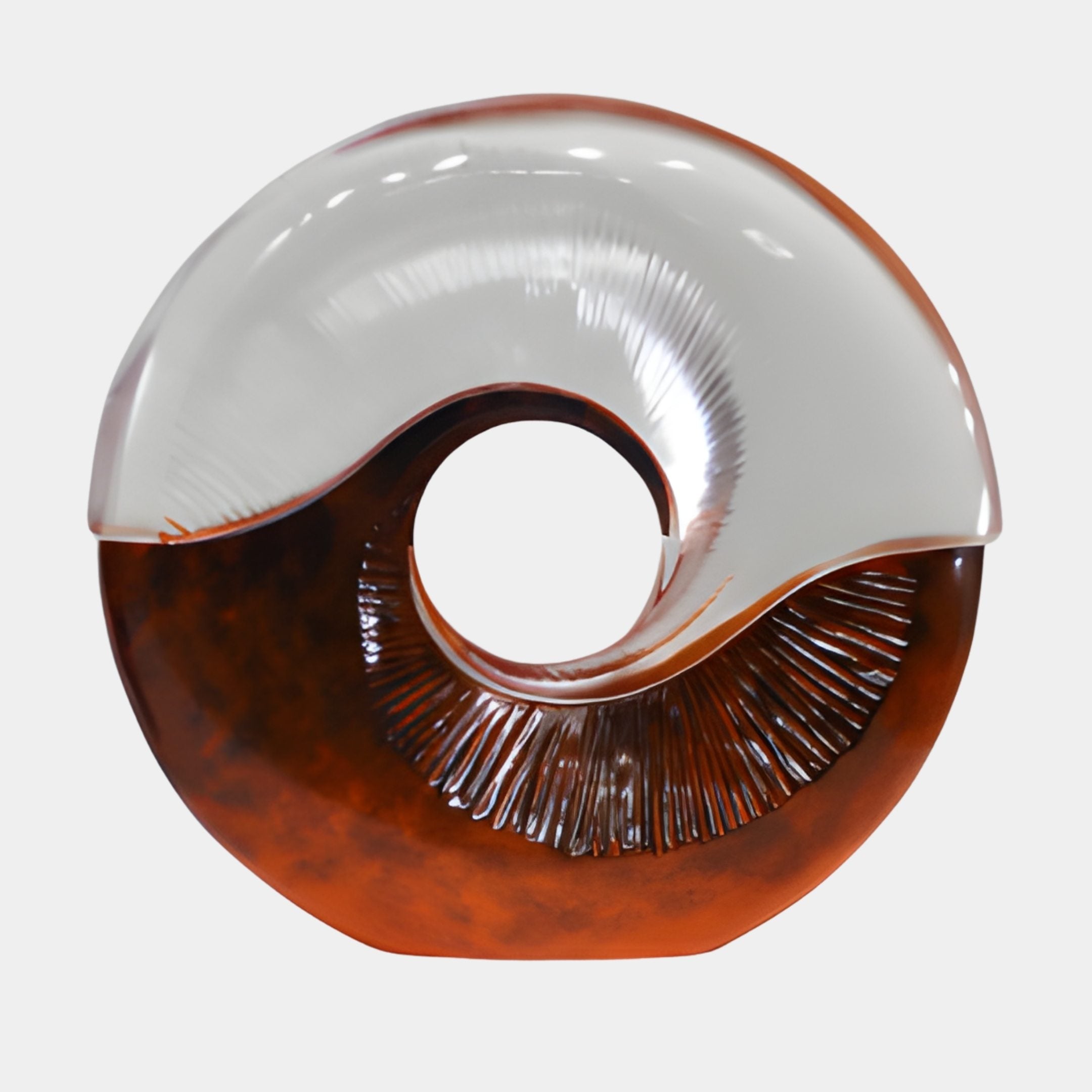 Amber and clear resin yin-yang ring sculpture by Giant Sculptures, with a frosted clear upper curve and warm amber lower half featuring fine radiating lines, on a plain background.