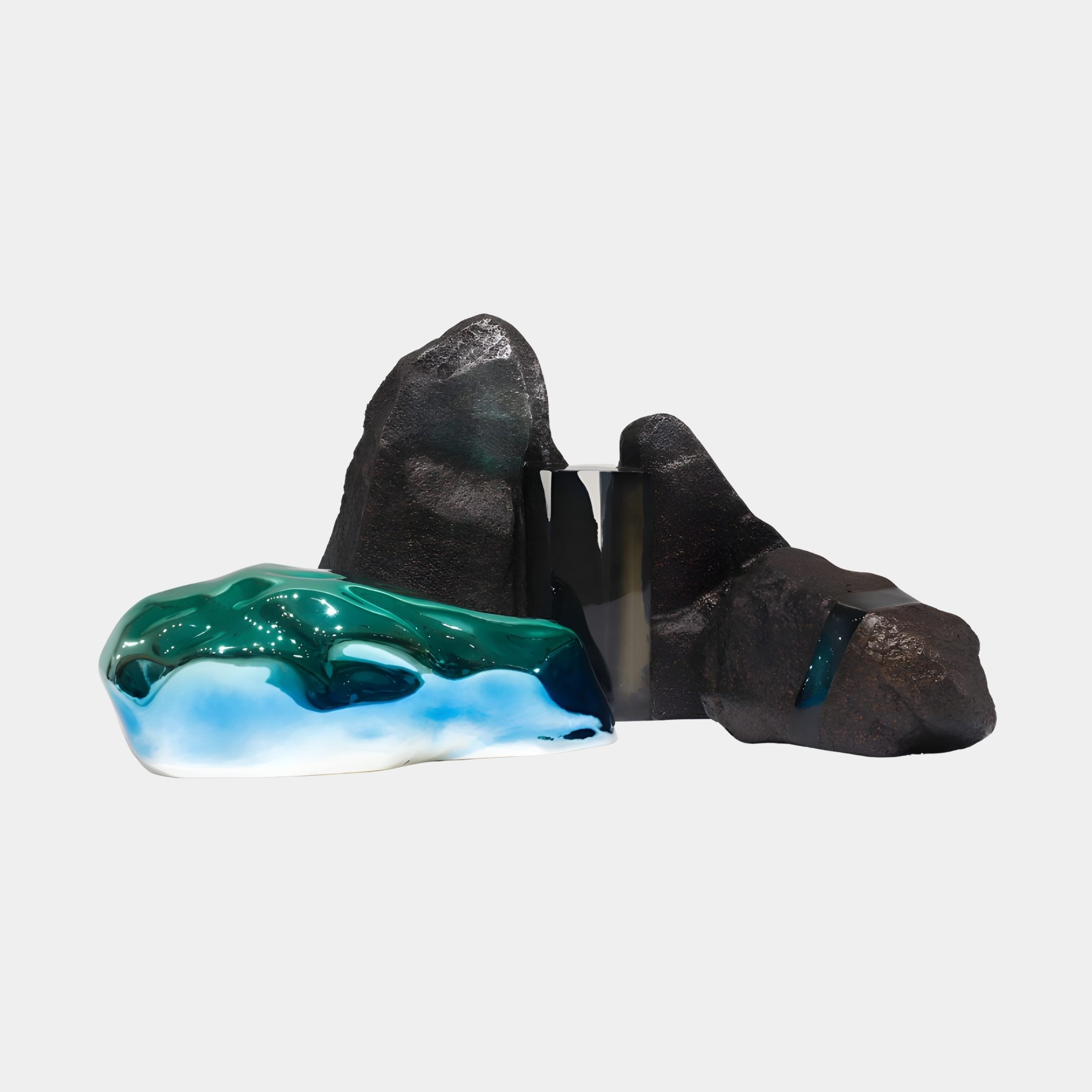 Blue Rippled Resin & Black Fiberglass Rock Sculpture by Giant Sculptures, showing craggy black peaks beside a flowing blue and green resin pool on a white background.