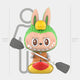 The Camp Life Kayaker Labubu Sculpture by Giant Sculptures shows a cartoon bunny in a green and yellow animal costume with a paddle in a red and yellow kayak. This indoor piece stands 160 cm (5 ft 3 in) tall, as marked by the gray outline behind it.