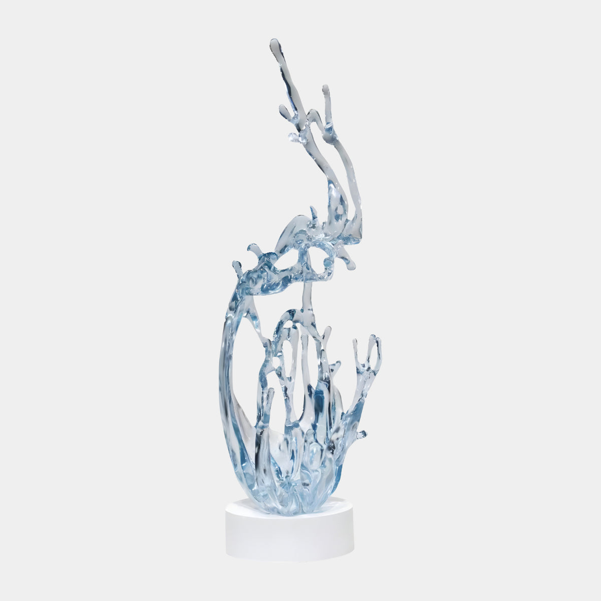 Pale Blue Leaping Spray Resin Sculpture - 120cm, a wave-like jet of pale ice-blue resin on a round white base, set against a plain light background.