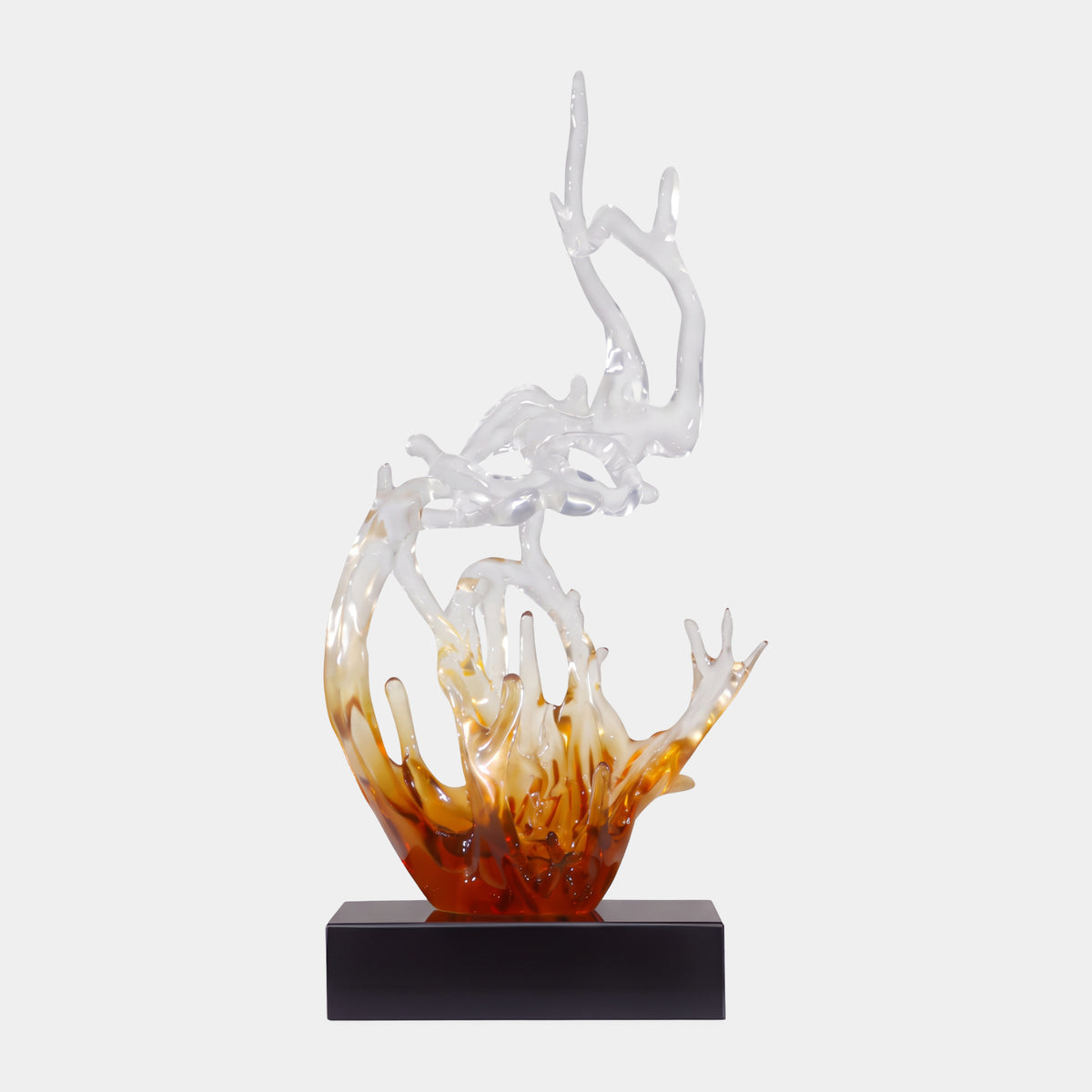 Amber Graded Miniature Splash Resin Sculpture - 56cm, a wave-like resin piece shifting from deep amber at the base to clear branching tendrils above, on a black rectangular base against a plain white background.