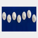 The Virello Deep Blue & White Disc Leather 3D Wall Art by Giant Sculptures features seven white, oval discs arranged in a horizontal wave pattern on a bold blue paneled wall for modern geometric decor.