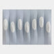 Virello Soft Blue & White Disc Leather 3D Wall Art featuring seven white oval discs with central indentations mounted on a panelled soft blue leather backdrop, shown against a light background.