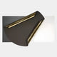 Valmeris Charcoal Fold Sculptural Metal 3D Wall Art featuring a curved charcoal iron form with gold-toned edge trims mounted over slate grey and white leather panels.