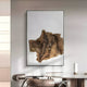 The Ravelle Brown Crest Felt 3D Relief Wall Art by Giant Sculptures features wavy, layered wooden textures and hangs on a light gray wall above a modern dining table with curved chairs and minimalist decor.