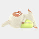 A cute, furry creature with bunny ears and a red nose lies on its back in a playful pose, hugging a green bean-shaped object—the 100cm Lazy Yoga Lay Down Labubu Sculpture by Giant Sculptures, radiating whimsical fibreglass charm.