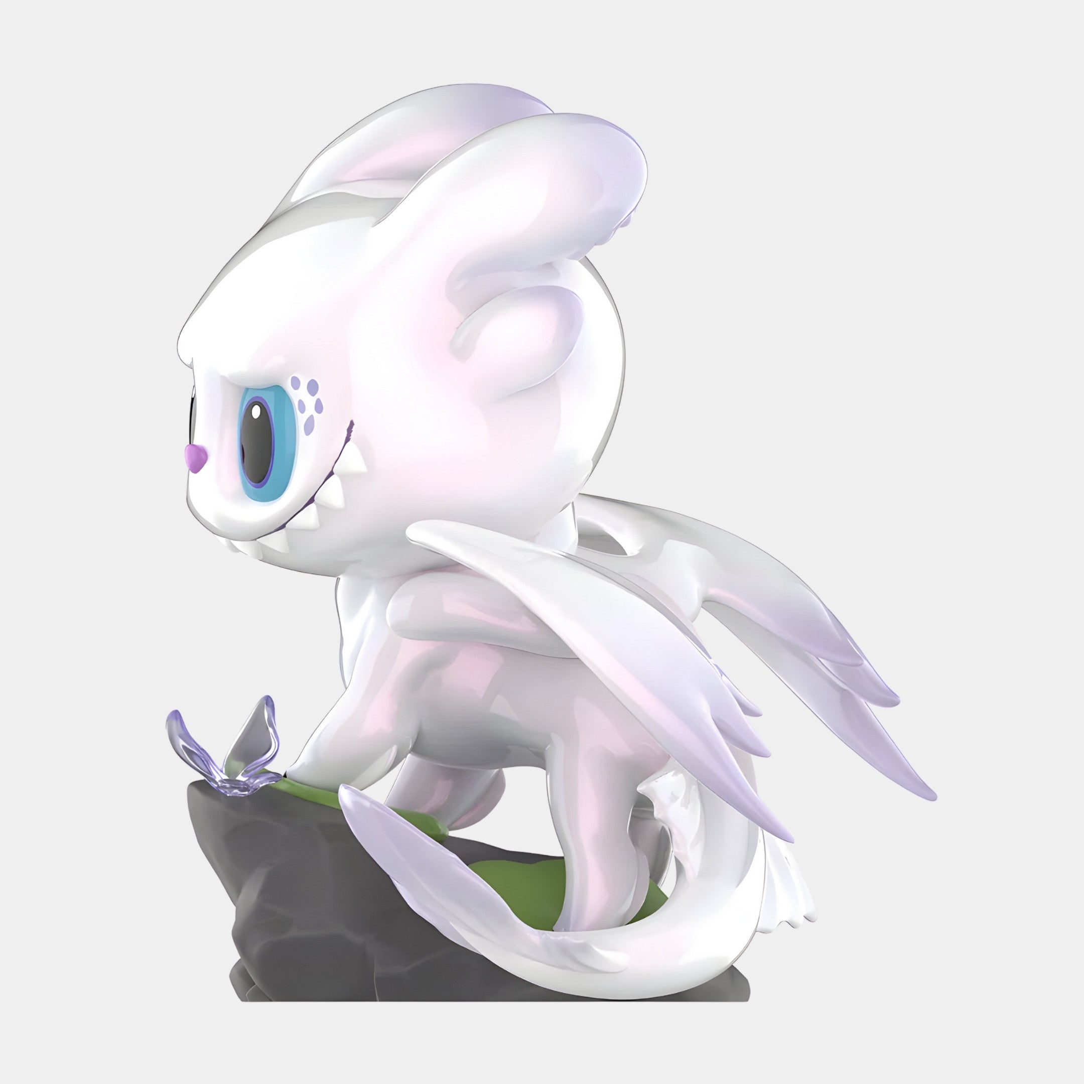 The Dragon Bond Light Fury Labubu Sculpture by Giant Sculptures stands 100cm tall, featuring a cute white dragon with blue eyes and translucent wings on a rock, playfully eyeing a butterfly. Its glossy finish gives it a charming fibreglass look.