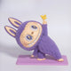 The Lazy Yoga Little Bird Labubu Sculpture - 100cm by Giant Sculptures features a charming, wide-eyed figure leaning on a lilac mat, smiling and holding a yellow bird aloft—an adorable fibreglass piece full of contemporary character.