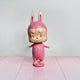 The Little Monster Pink Labubu Sculpture - 100cm by Giant Sculptures features bunny ears, big eyes, and a mischievous grin on a matching pink base—ideal as playful interior décor against pale backgrounds and floors.