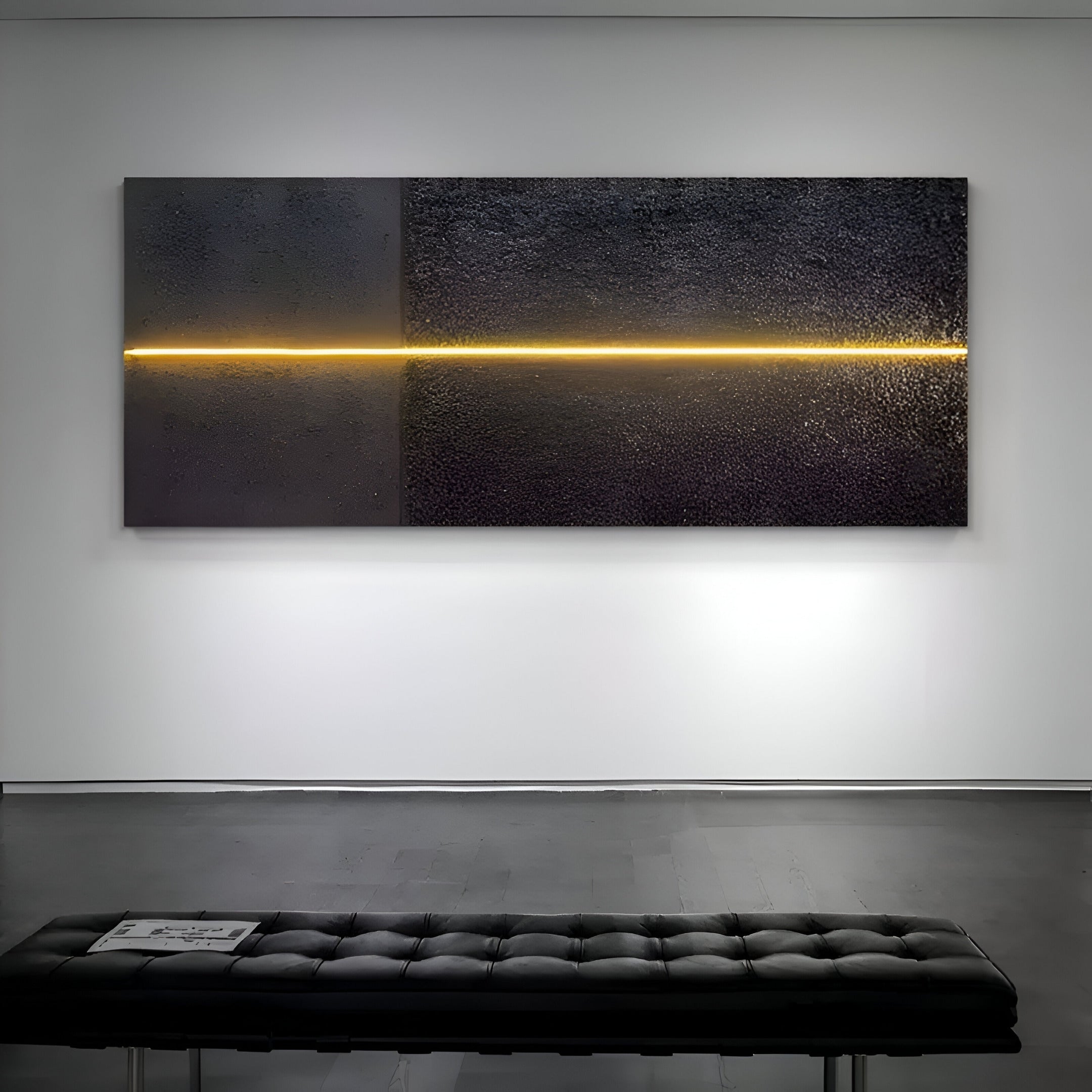 The Eternia Midnight Textured Oil Painting LED Wall Art by Giant Sculptures features a minimalist black textured surface with a central horizontal line of warm yellow light enhanced by LEDs, mounted on a white wall with a black tufted bench in front.