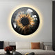 A modern living room features Giant Sculptures Genesis Golden Halo 3D Resin Crystal Porcelain LED Wall Art, resembling an abstract eye with swirling brown, black, and gold. Below, a white couch is adorned with a black and rust pillow, while a red floral arrangement graces the table.