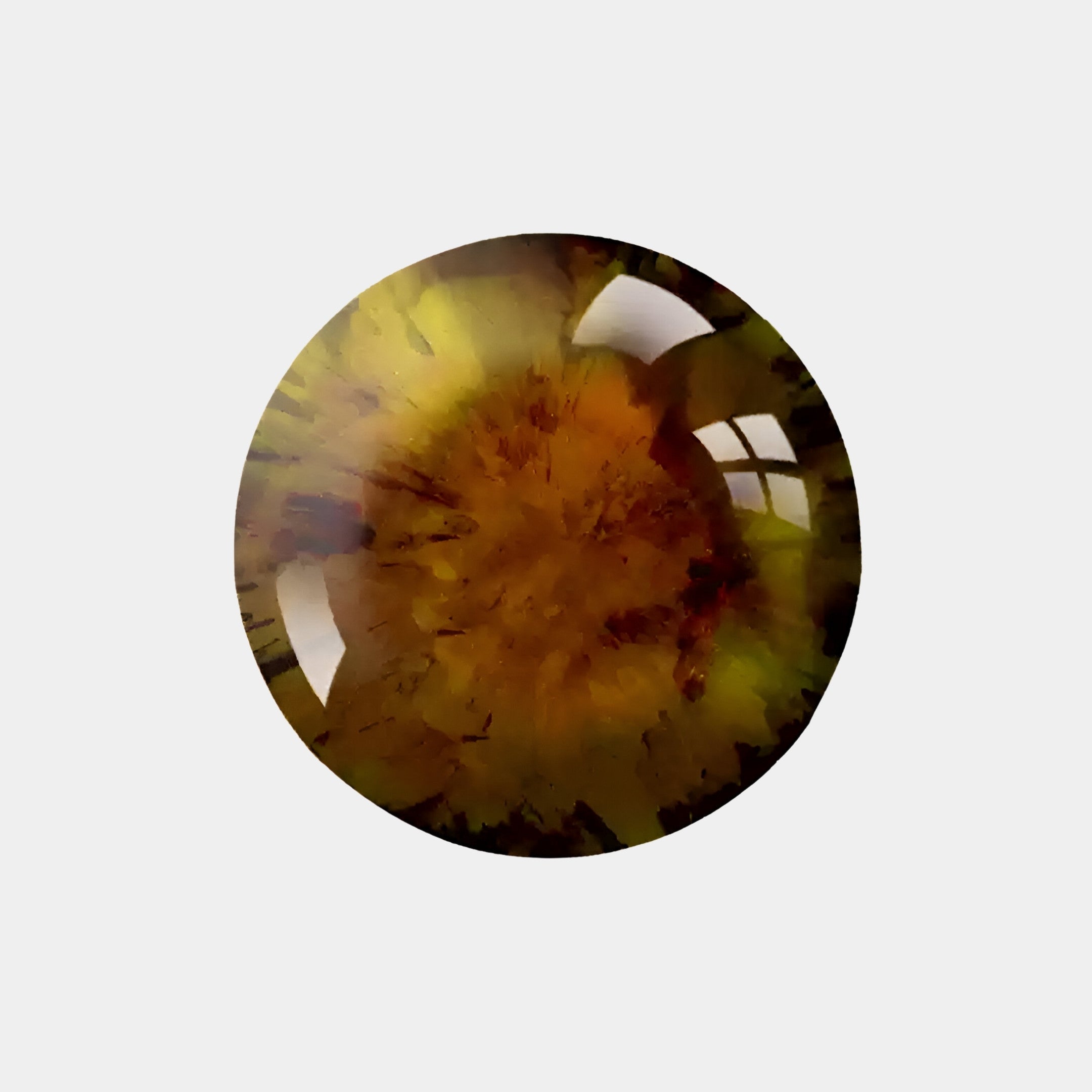 A close-up of the Genesis Sunburst 3D Resin Crystal by Giant Sculptures reveals a round, polished gemstone with yellow, brown, and green hues. Its reflective surface creates an abstract burst, perfect for modern design, set against a plain white background.