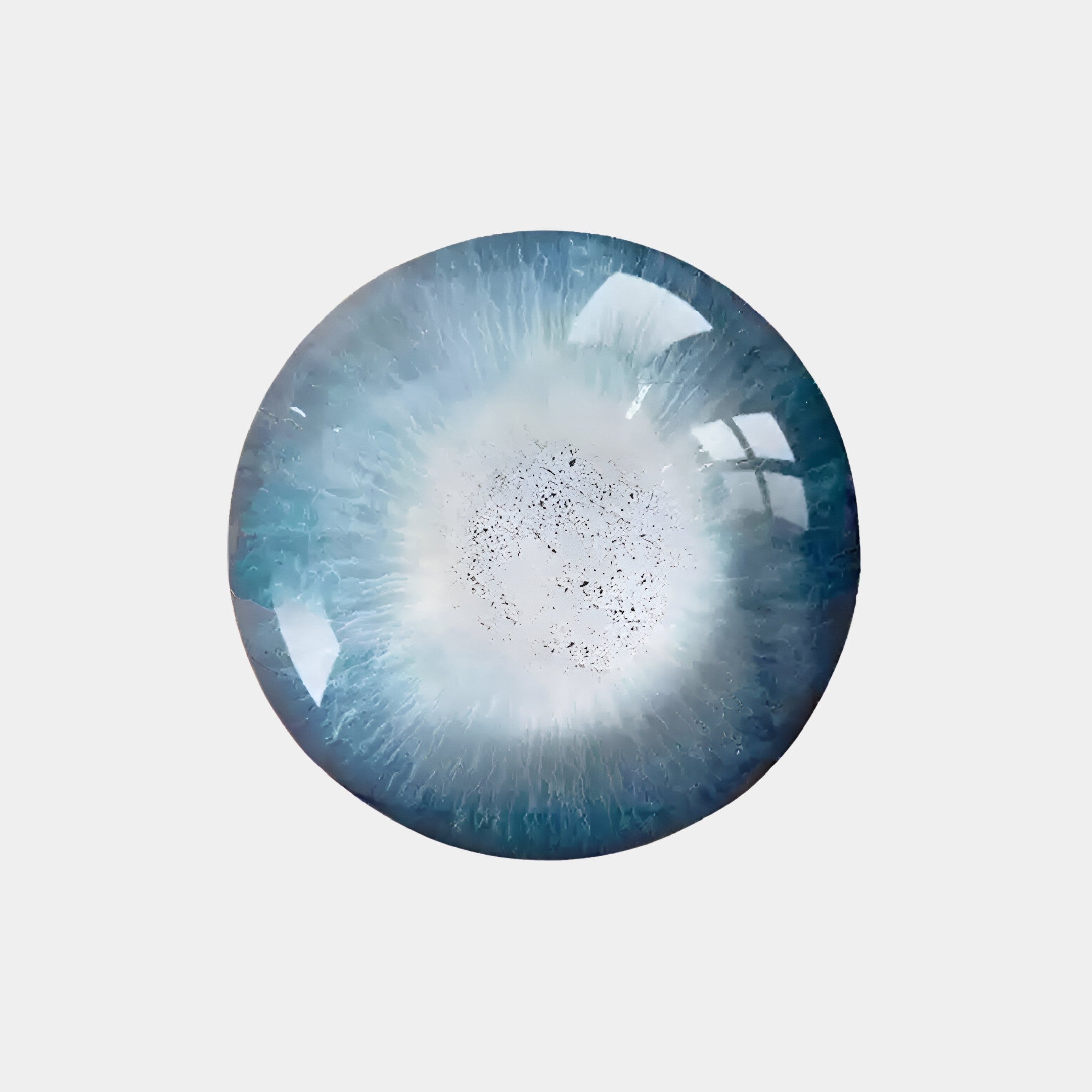 A glass marble with a swirling blue and white pattern, resembling an eye or galaxy, sits against a plain white background. Its reflective surface mimics the captivating glow of Giant Sculptures Genesis Frost 3D Resin Crystal Porcelain LED Wall Art.