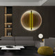 A modern living room features a gray sectional sofa, a round white side table, and a yellow pouf. Giant Sculptures Onyx Golden Aura Acrylic 3D LED Wall Art with concentric lines adorns the wall, enhanced by ambient lighting. Minimalist decor rests on shelves with a textured acrylic backdrop.